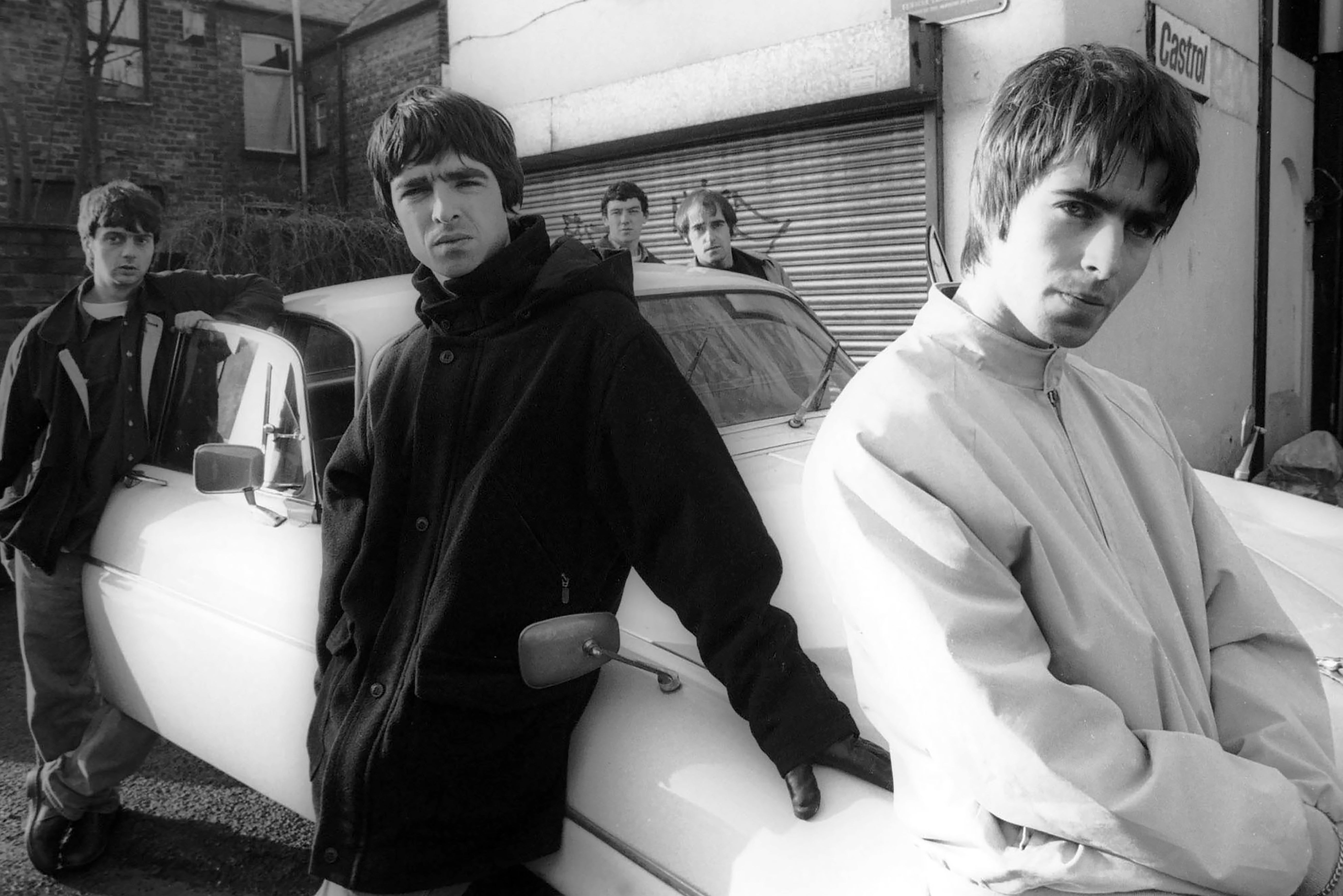 Manc motor mouths: Oasis (from left, Paul McGuigan, Noel Gallagher, Tony McCarroll, Paul ‘Bonehead’ Arthurs and Liam Gallagher) commandeer a Jaguar XJ6 for a November 1993 shoot