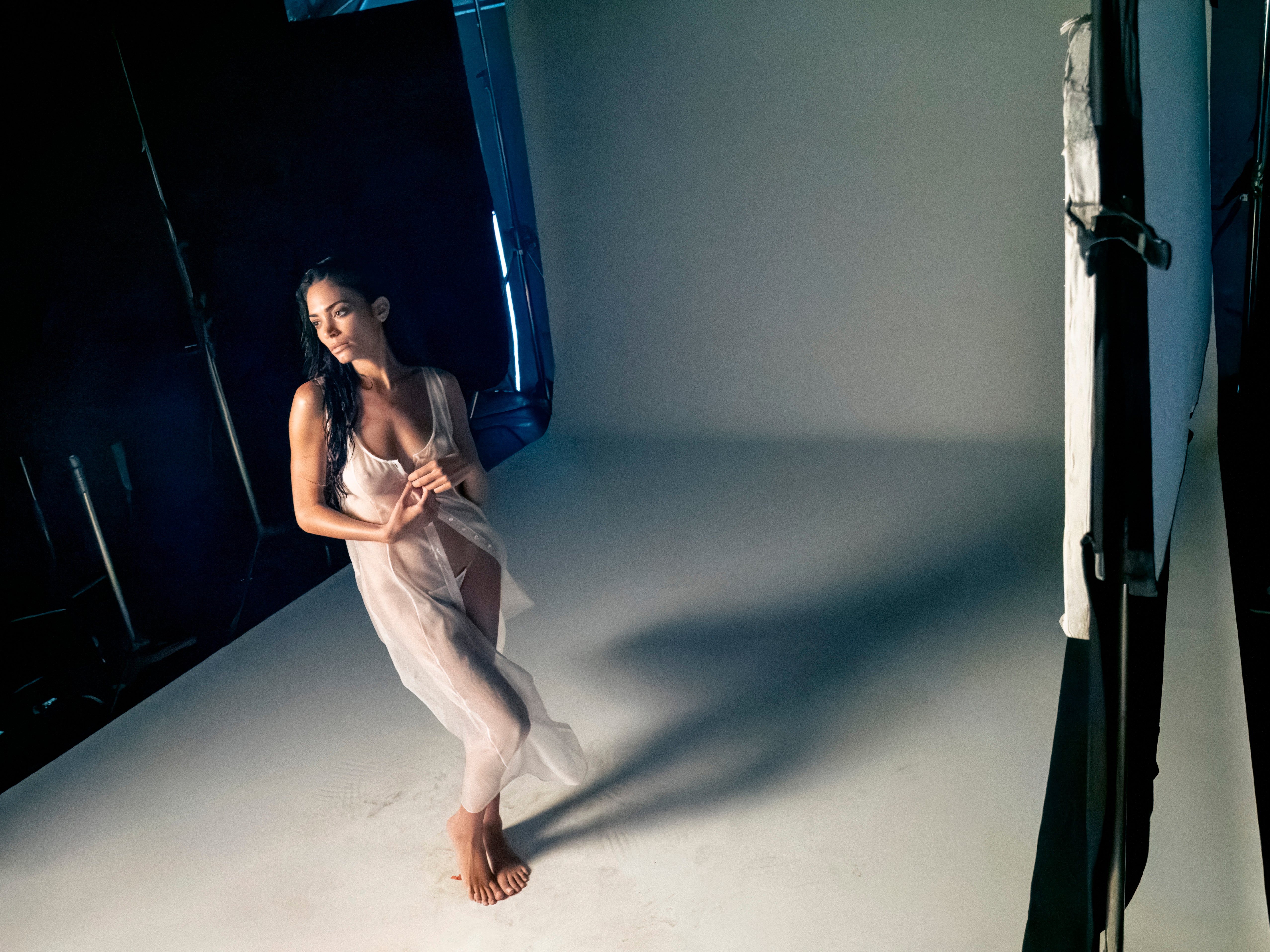 Elodie Di Patrizi wears a sheer garment inside the 2025 Pirelli Calendar studio