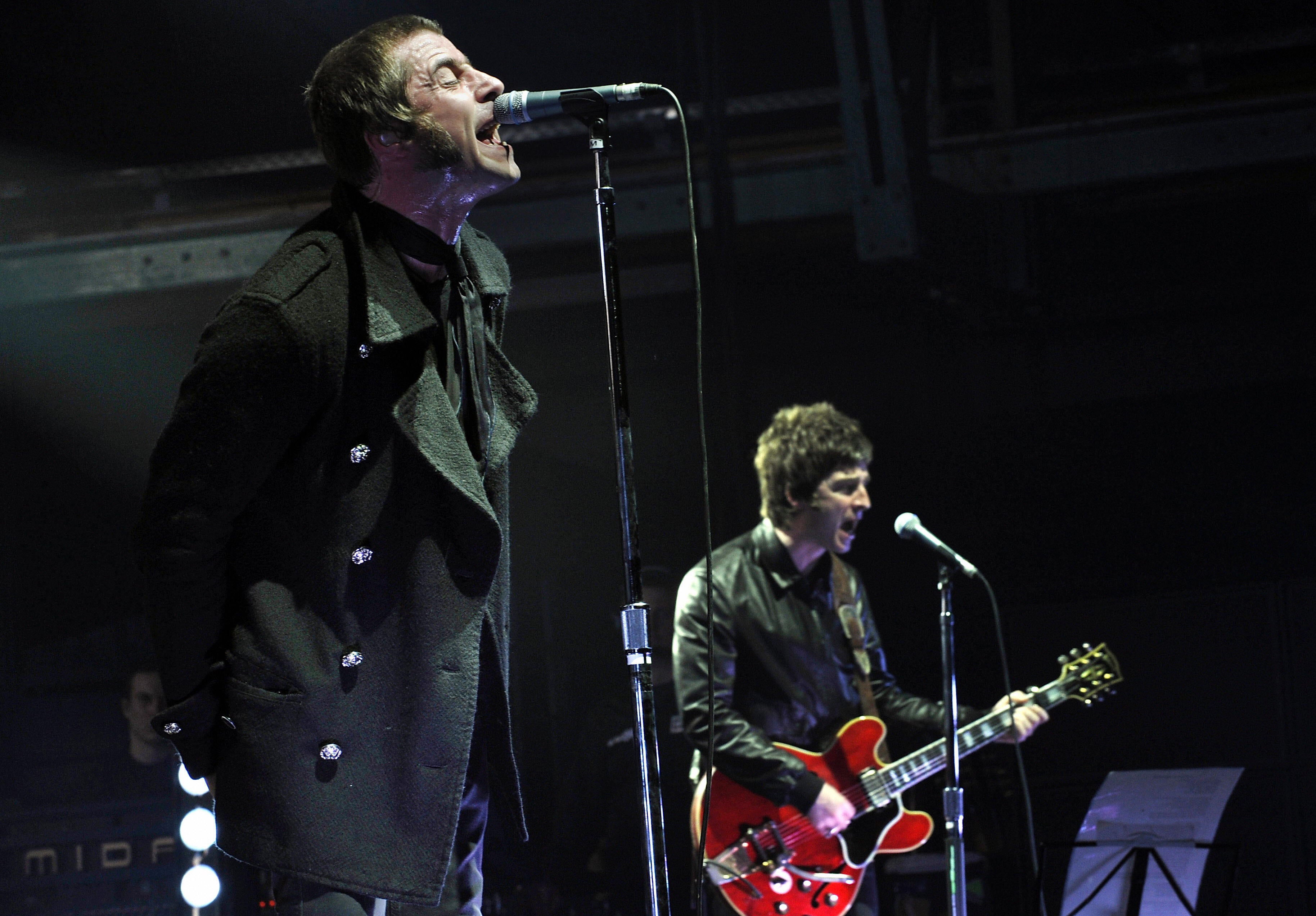 Liam and Noel Gallagher (right) perform on stage in Munich in February 2009