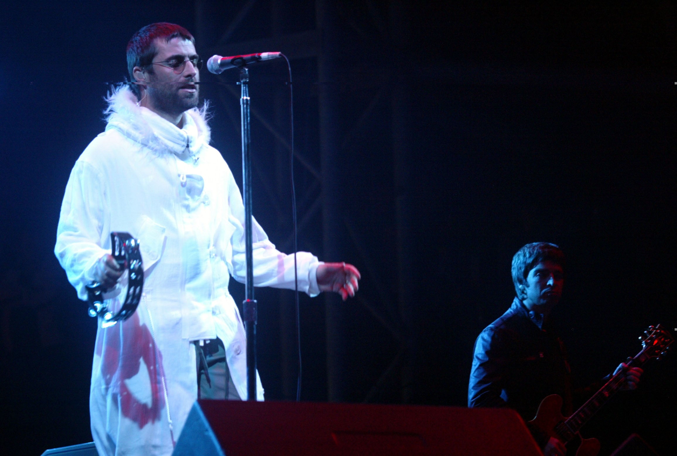 Liam and Noel Gallagher of Oasis perform on the Pyramid Stage during the 2004 Glastonbury Festival