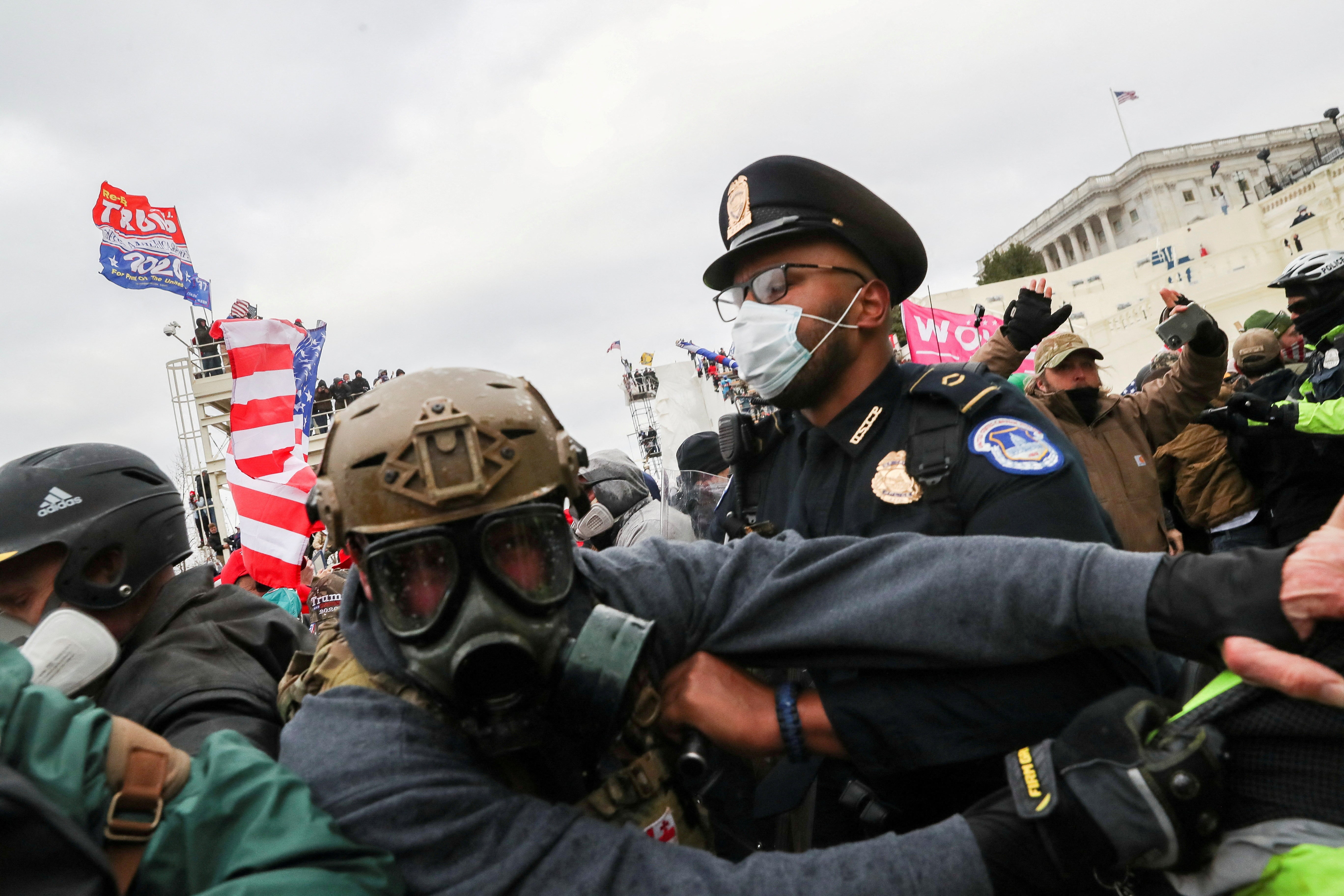 A mob of Donald Trump’s supporters try to break through law enforcement officers outside the Capitol building on January 6, 2021.