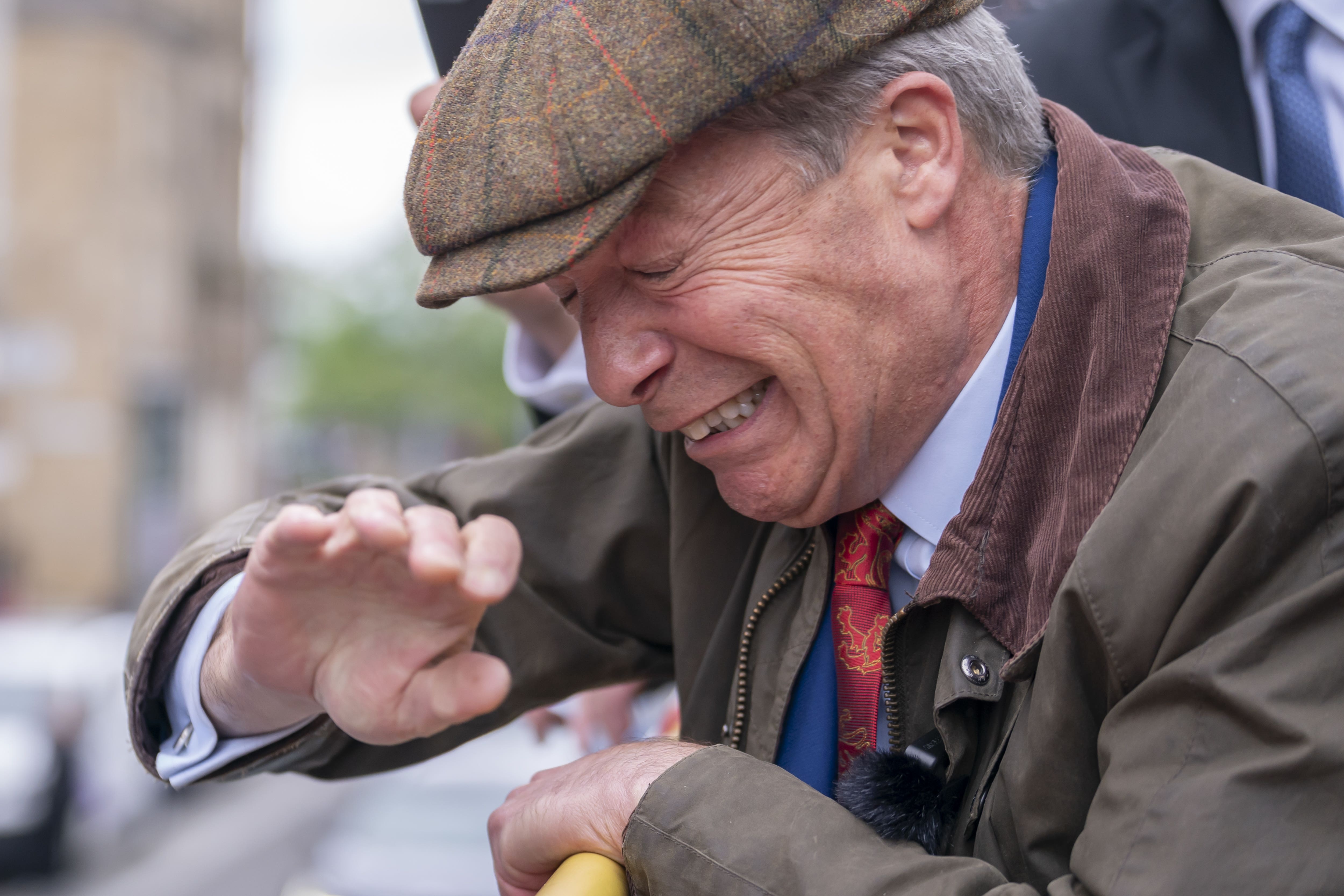 Reform UK leader Nigel Farage reacts after something is thrown towards him on the Reform UK campaign bus in Barnsley, South Yorkshire, whilst on the General Election campaign trail on June 11 (Danny Lawson/PA)