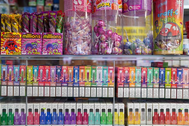 <p>Disposable vapes of varying flavours on sale in a store (Jacob King/PA)</p>