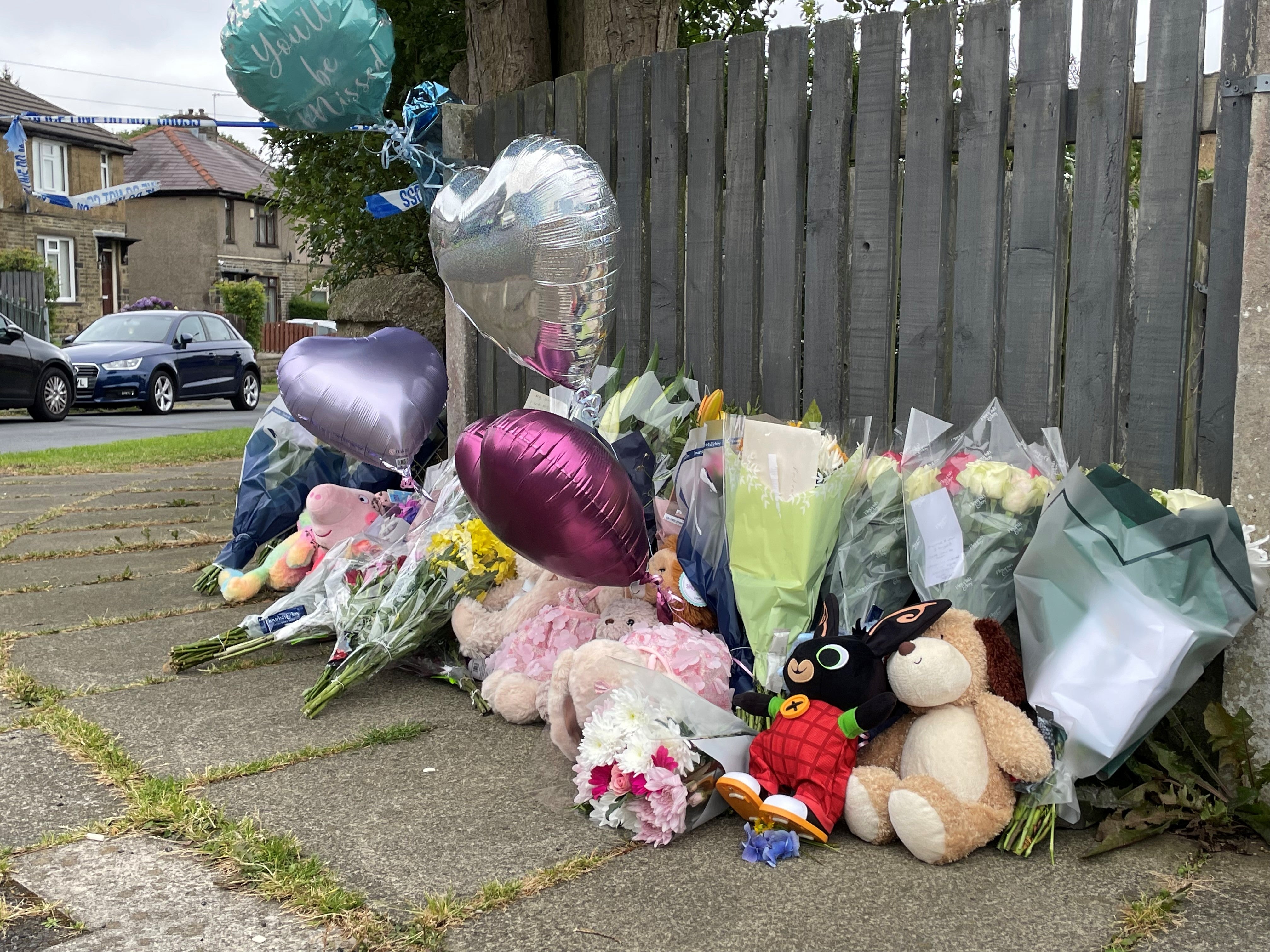 Flowers and tributes near the scene in Bradford after the mother and her three children were killed following the blaze at their home