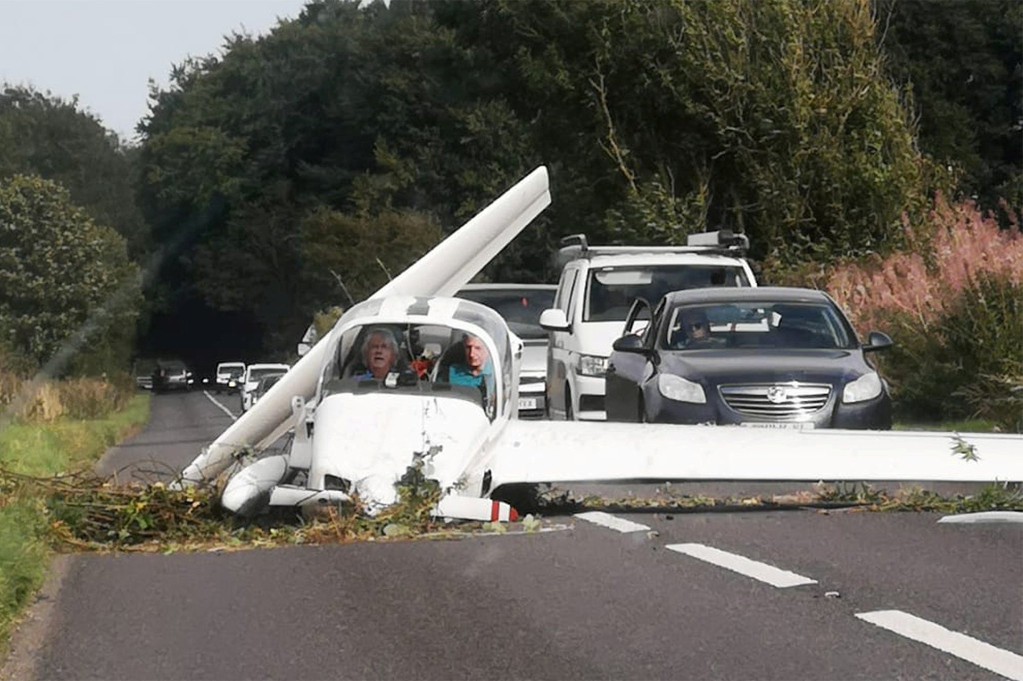 The pair on board can be seen grimacing in the cockpit