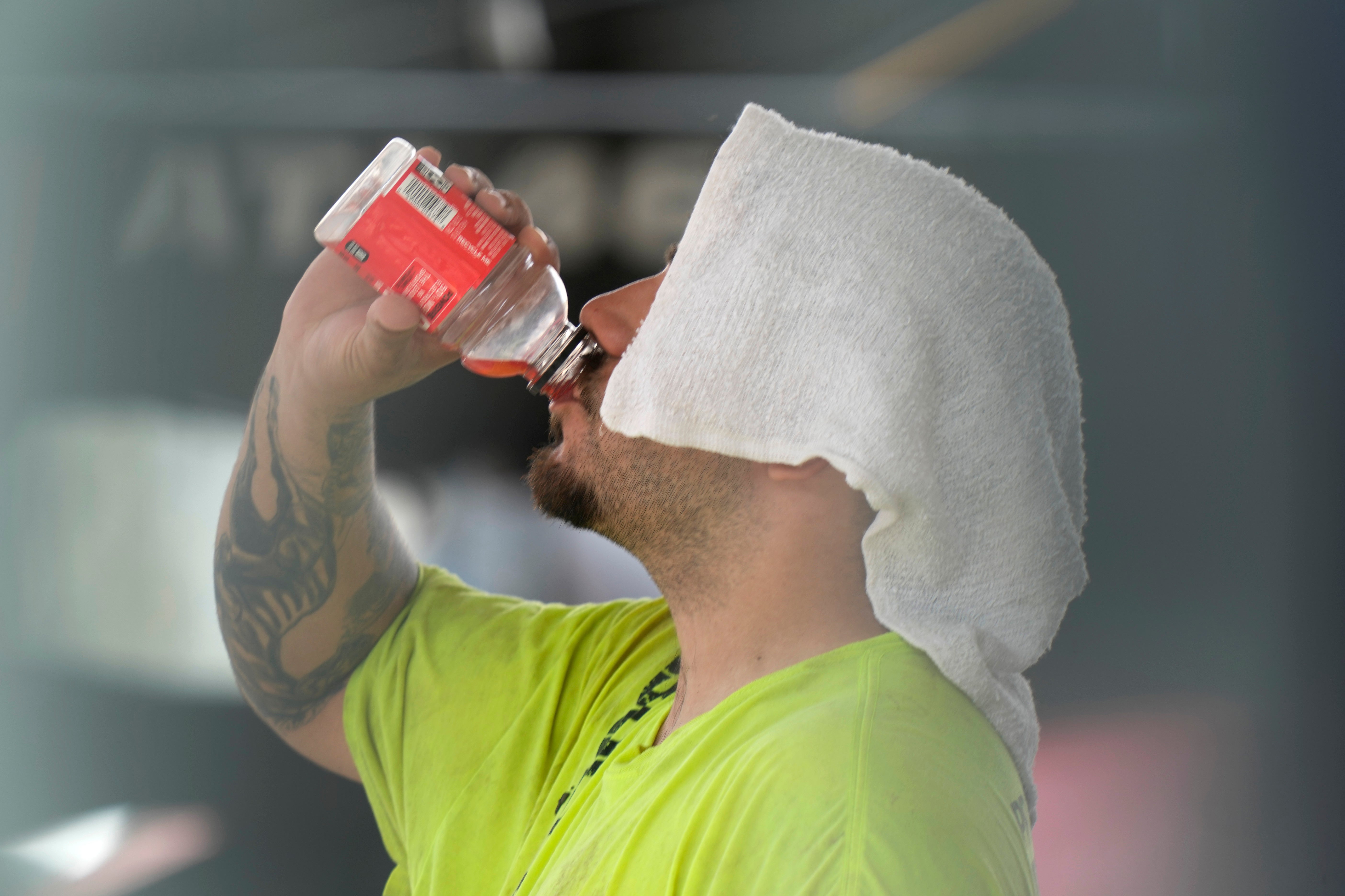 A construction worker hydrates at the Shedd Aquarium Tuesday. A late summer heat wave brought record temperatures to Chicago and other parts of the Midwest