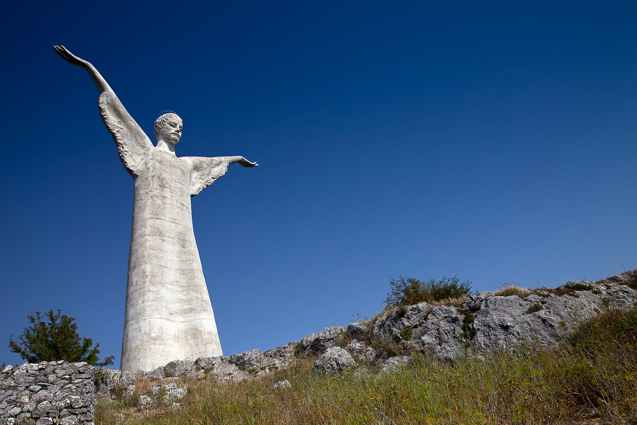 The statue of Christ the Redeemer, created in Carrara marble, is perched atop of the St Biagio mountain