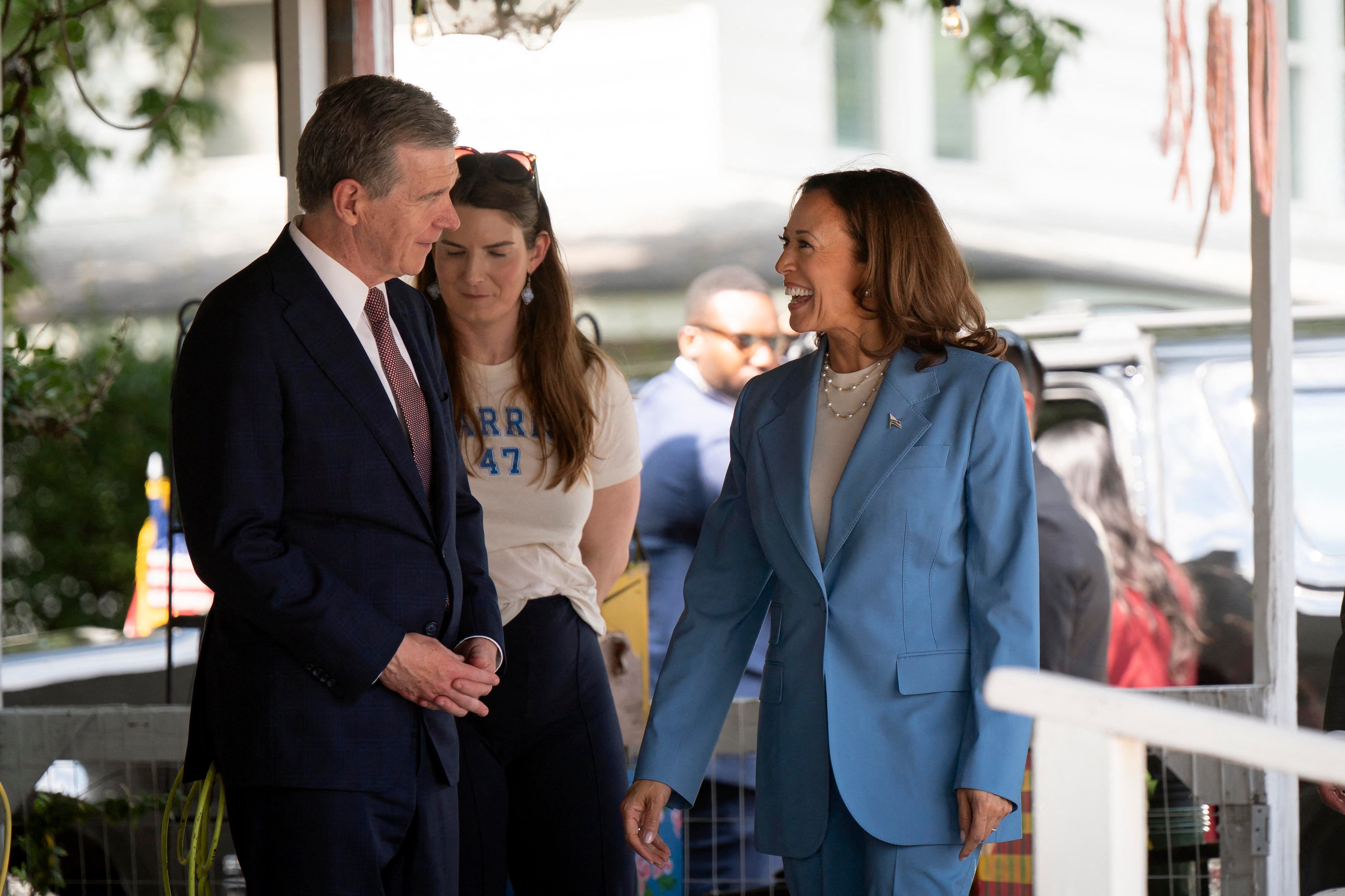 Kamala Harris speaks with North Carolina Governor Roy Cooper earlier this month. The Tar Heel state is now a toss-up and could go to either Donald Trump or Harris come November, a new report reveals