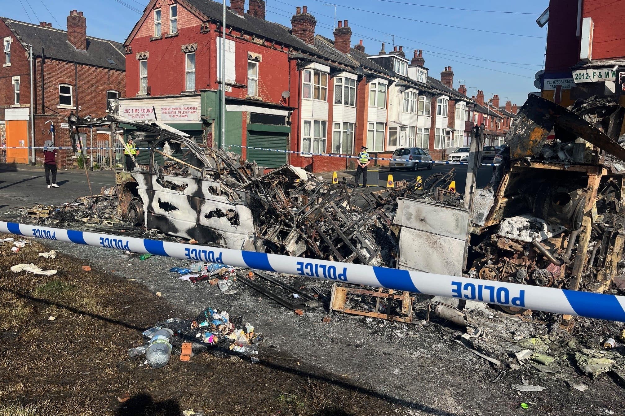 A burnt out car in the Leeds suburb of Harehills after vehicles were set on fire and a police car was overturned (Katie Dickinson/PA)