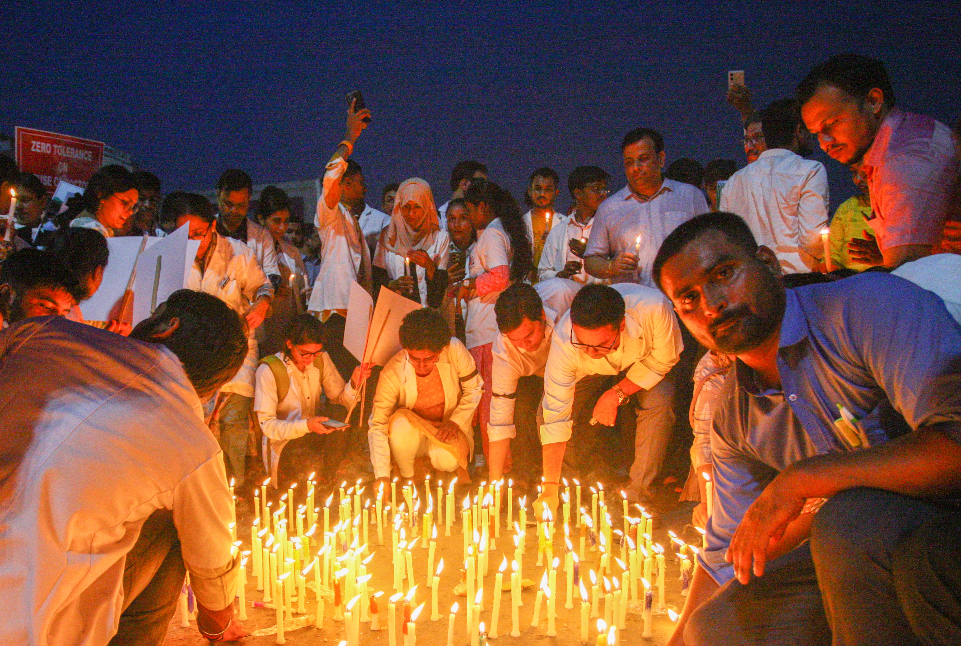 Senior and resident doctors take part in a candlelight march during a protest and nationwide strike against the rape and murder of the woman doctor