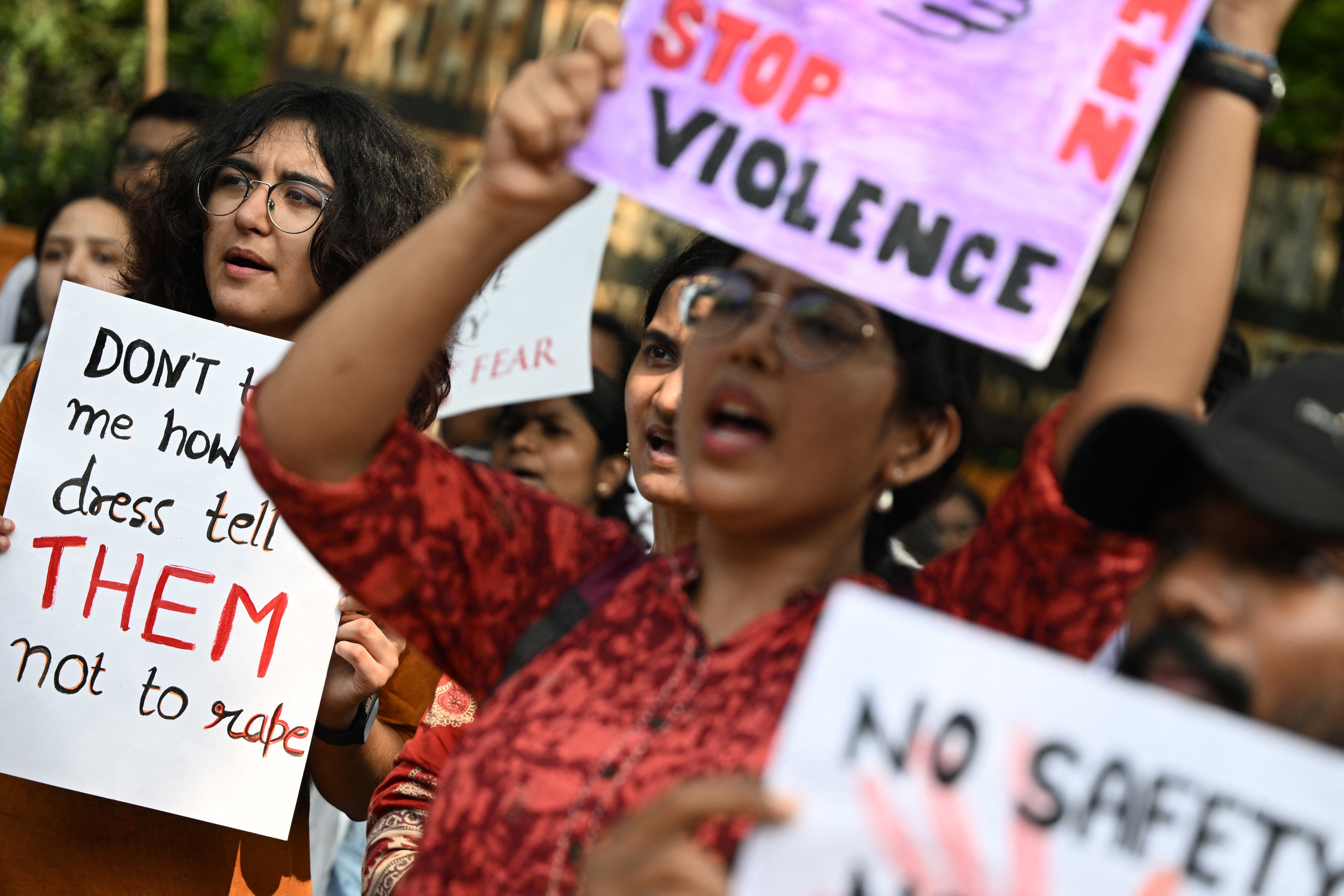 Medical professionals and students hold placards as they take part in a protest in New Delhi on 21 August 2024