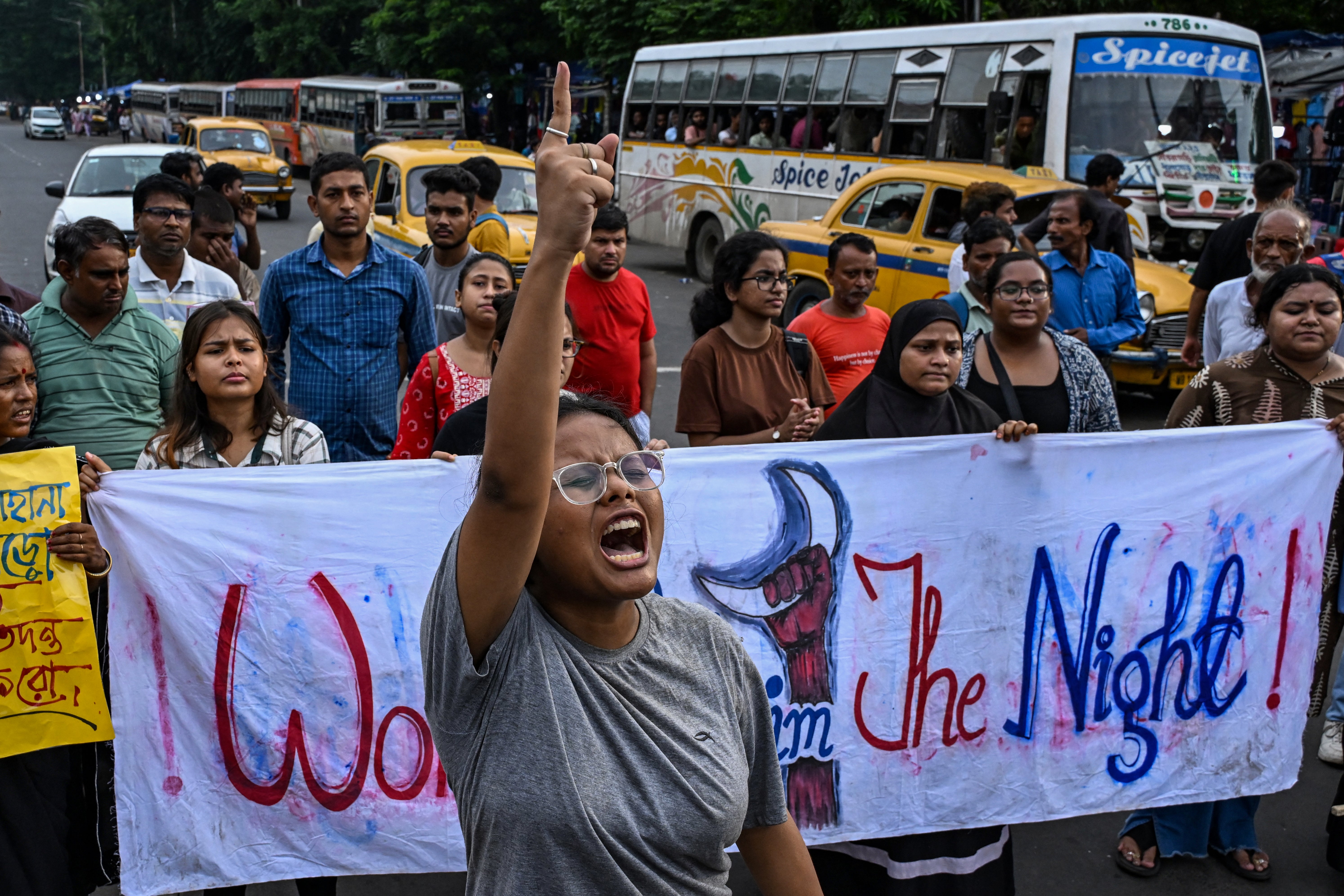 Activists shout slogans and display a banner during a protest rally to condemn the rape and murder of a doctor in India’s West Bengal state, in Kolkata on 25 August 2024