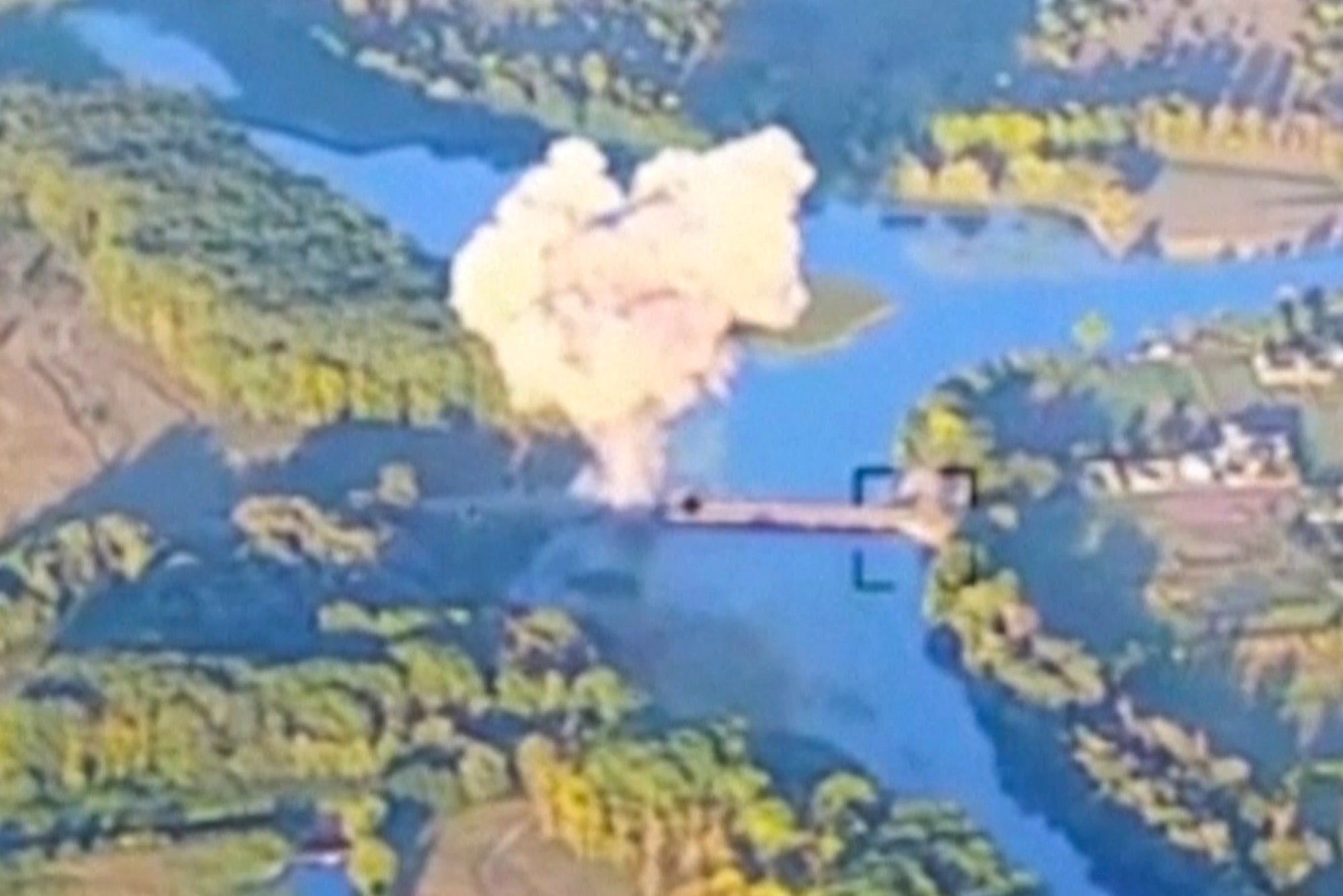 FILE - In an image taken from footage released by the Ukrainian armed forces on Aug. 18, 2024, smoke billows in what is said to show the destruction of a key bridge in Russia's Kursk region by Ukrainian forces