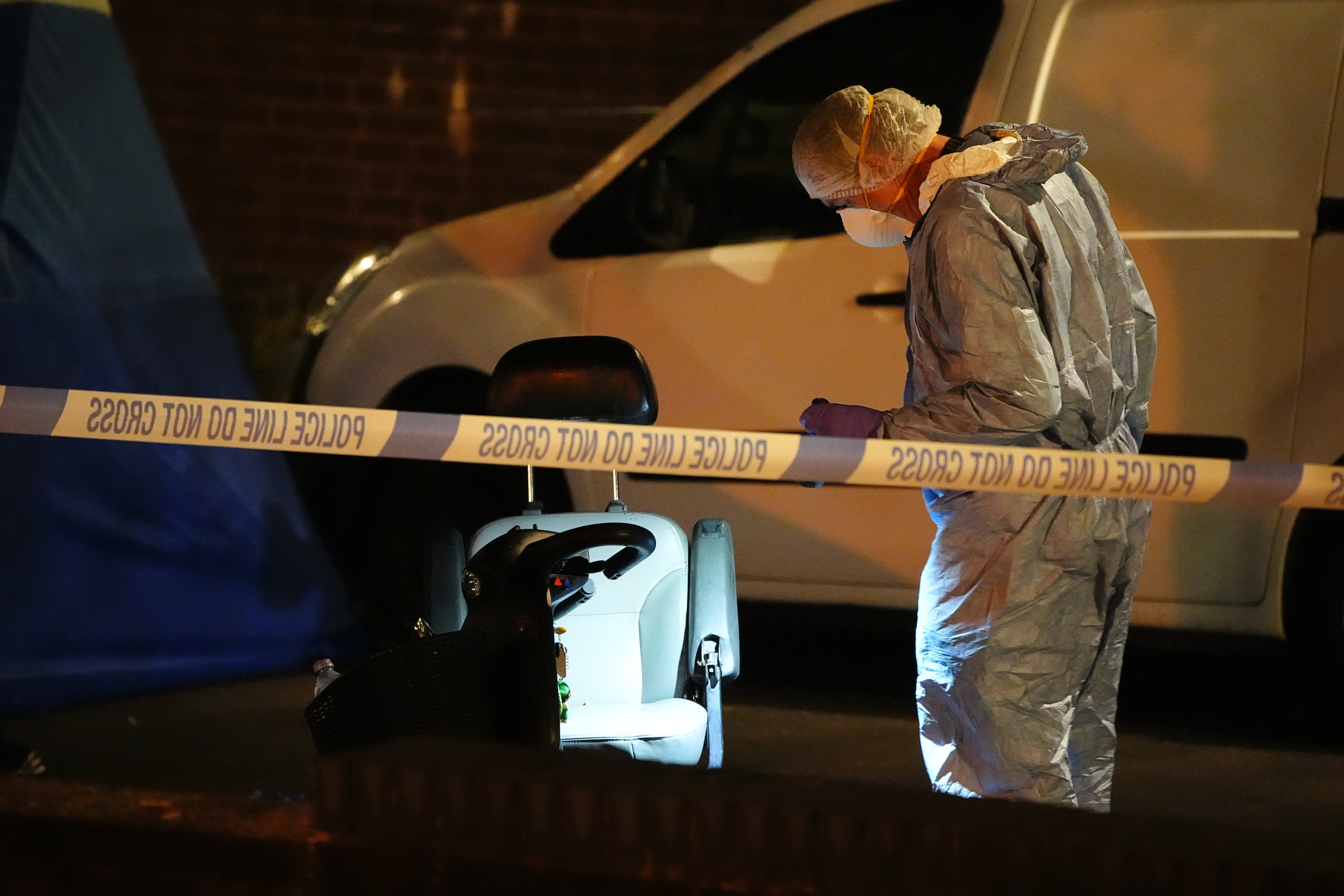 A forensic officer on Overbury Street near the scene in Rushmore Road in Clapton