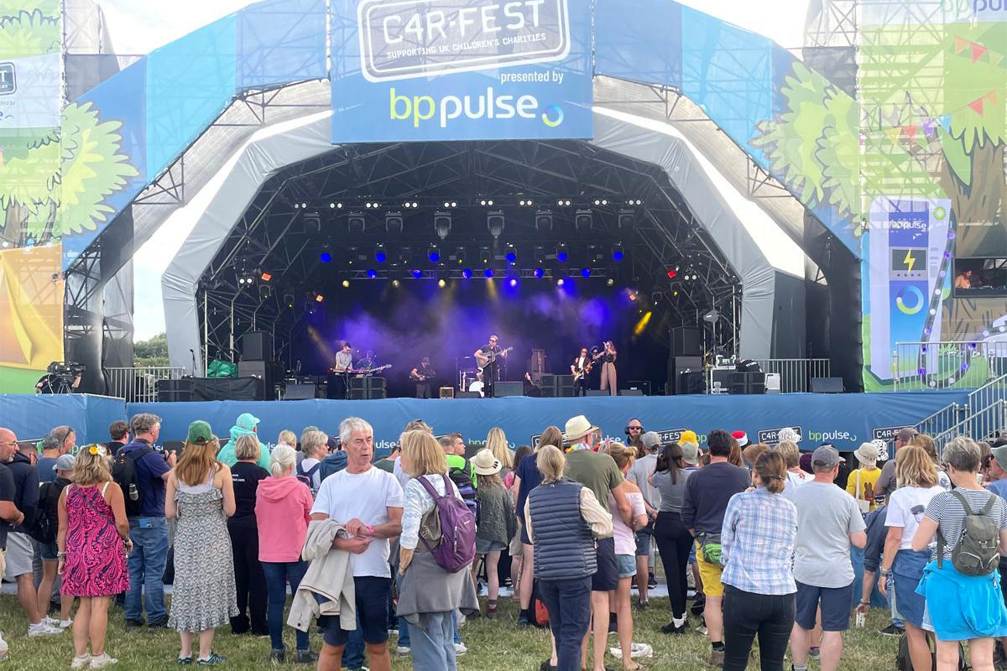 An artist entertains the crowd at CarFest 2024