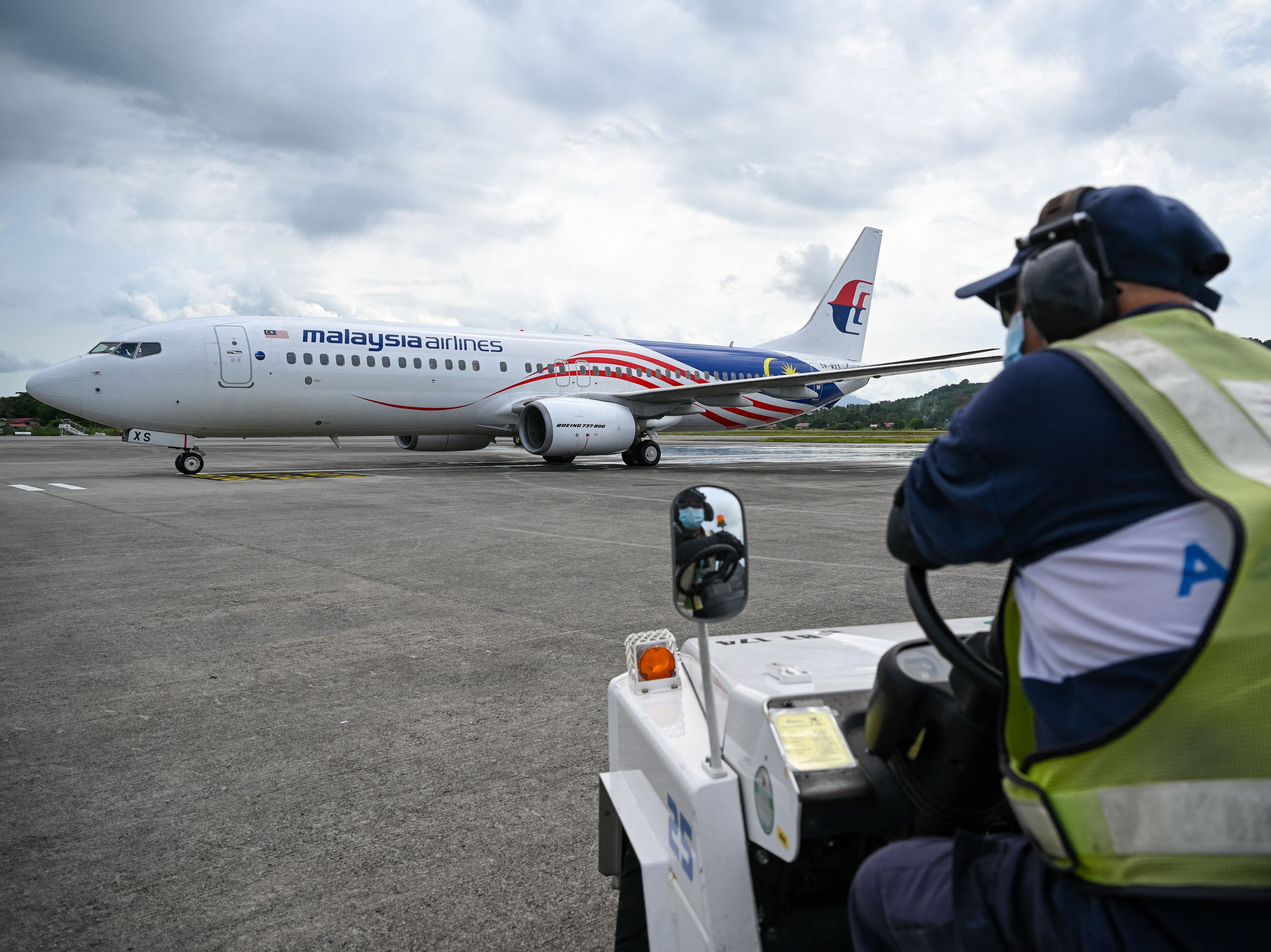 File. A ground staff member looks at the Malaysia Airlines aircraft