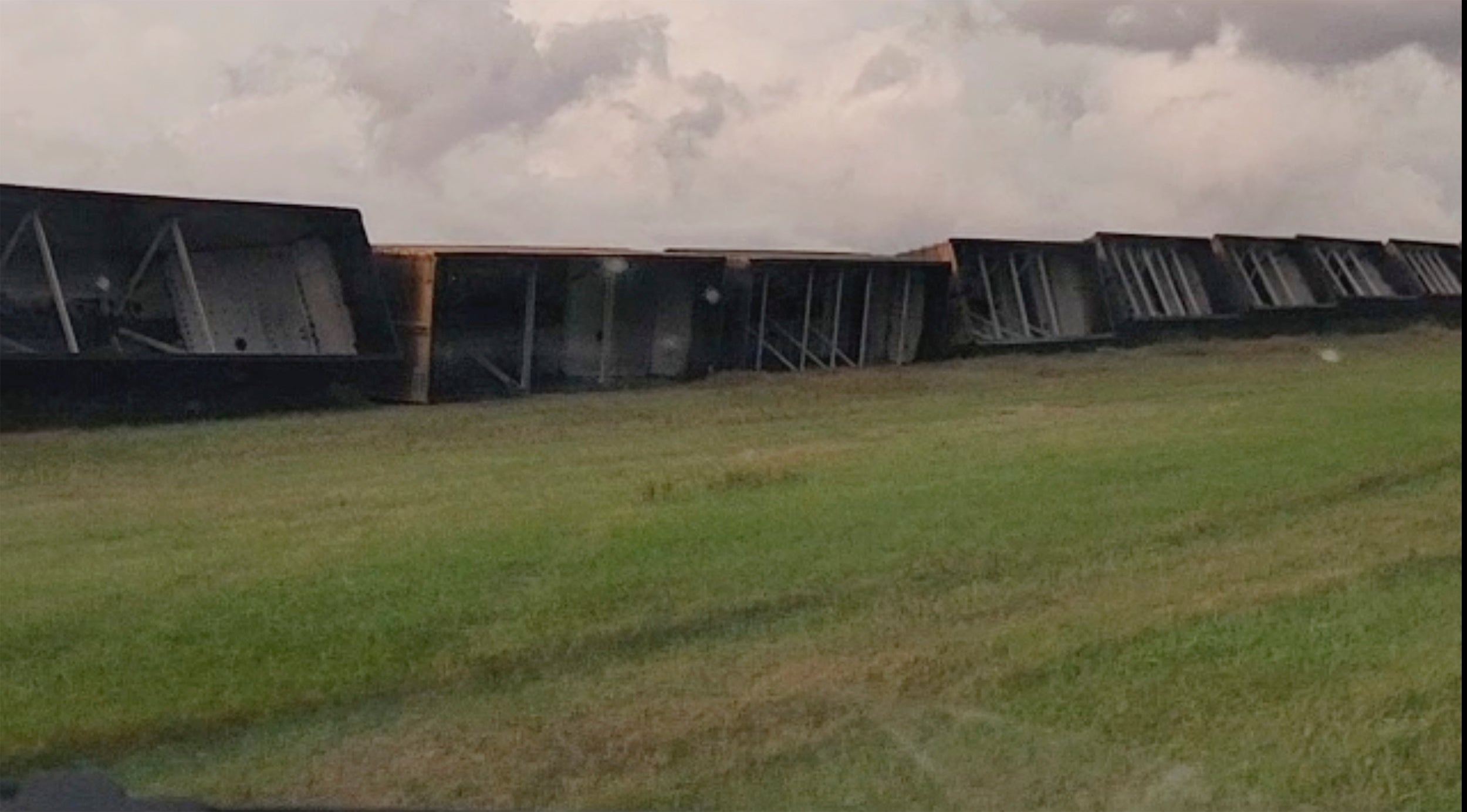 Train cars are seen knocked off railroad tracks on Thursday morning. The cars derailed in high winds from bad weather in the area near Steele, North Dakota