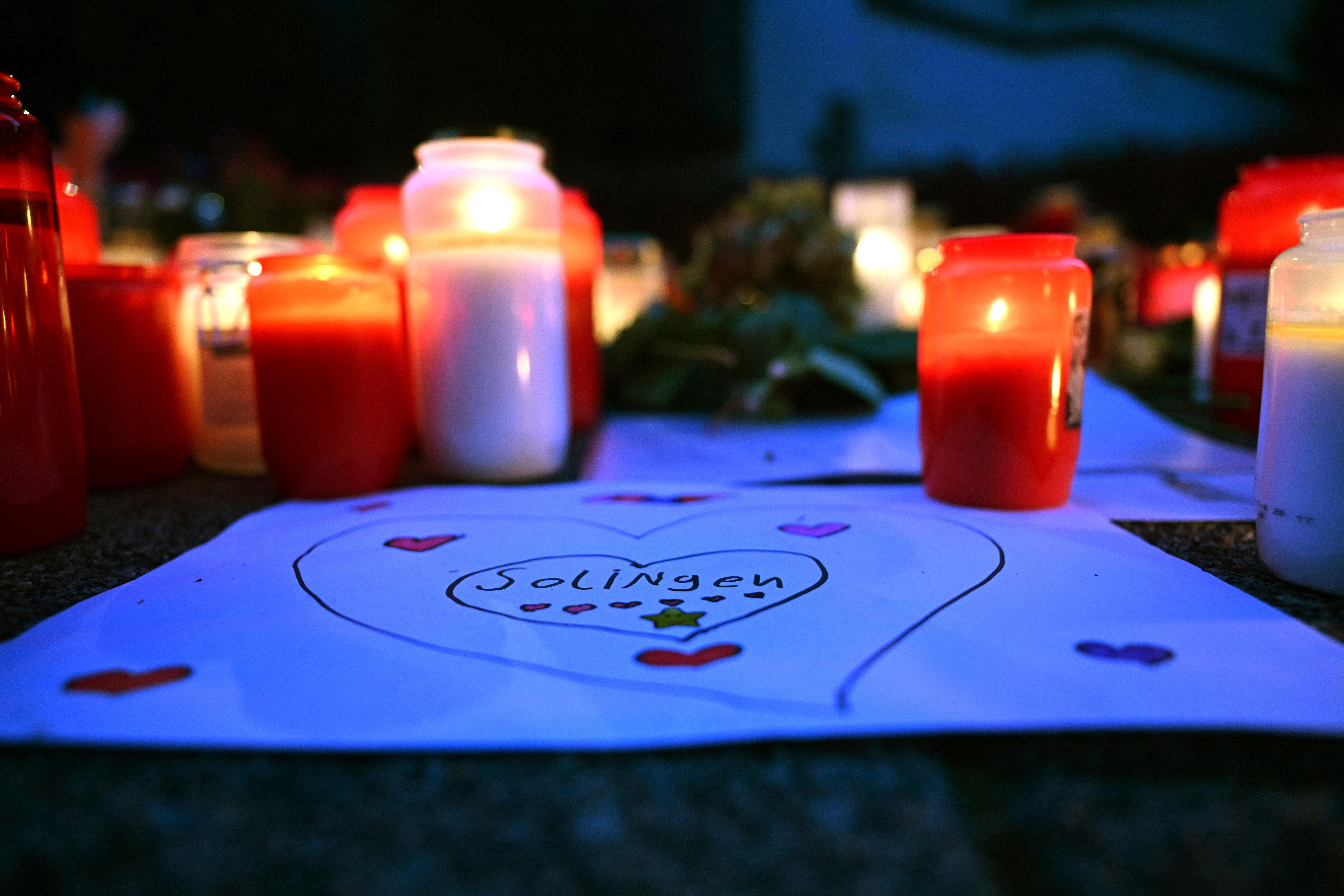 Tributes are left in Solingen after three people were killed and four were injured in a terror attack by a Syrian refugee