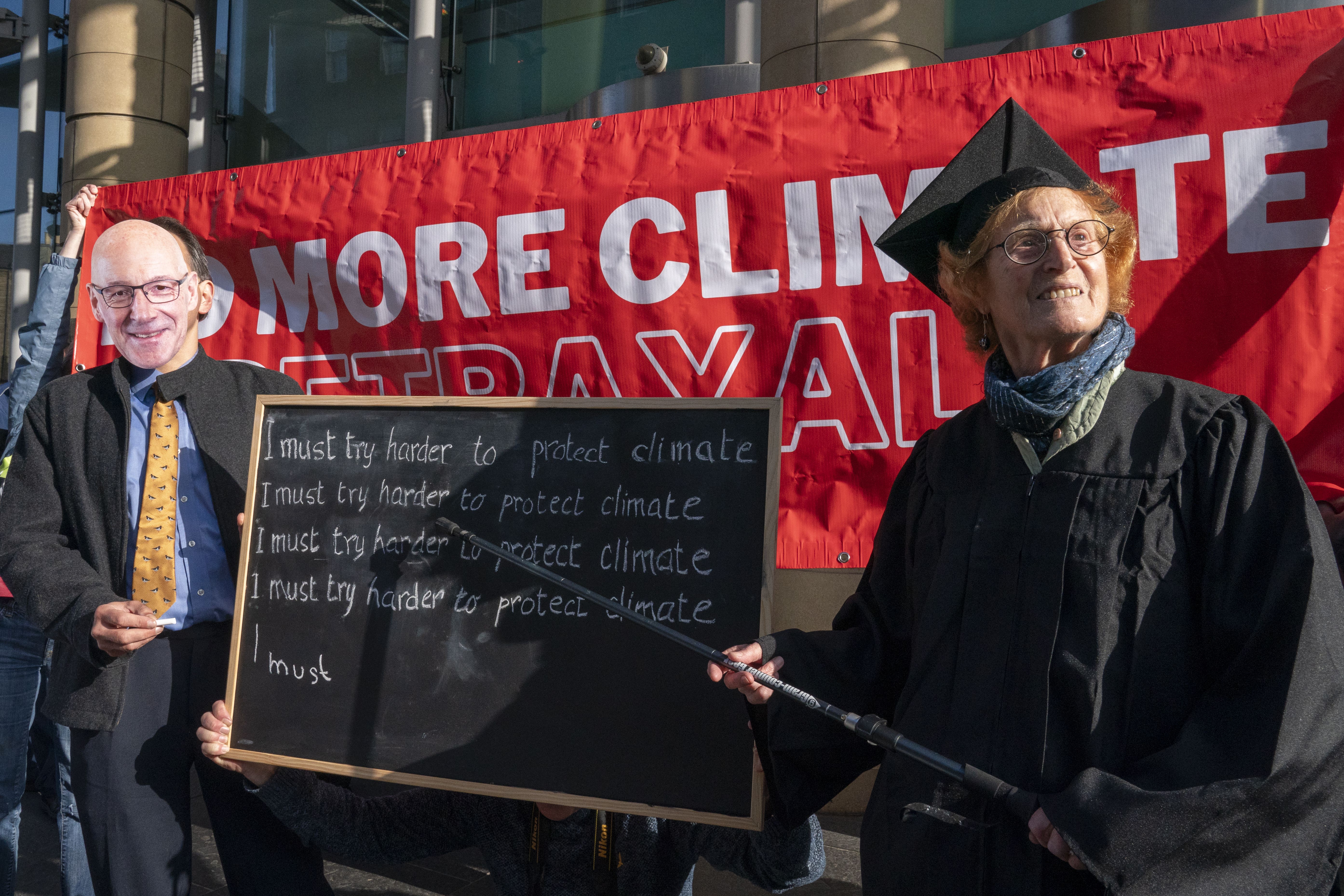 First Minister John Swinney’s former high school teacher Caro Wilkinson (right) joined protesters from the Edinburgh Climate Coalition at the start of the SNP conference (Jane Barlow/PA)