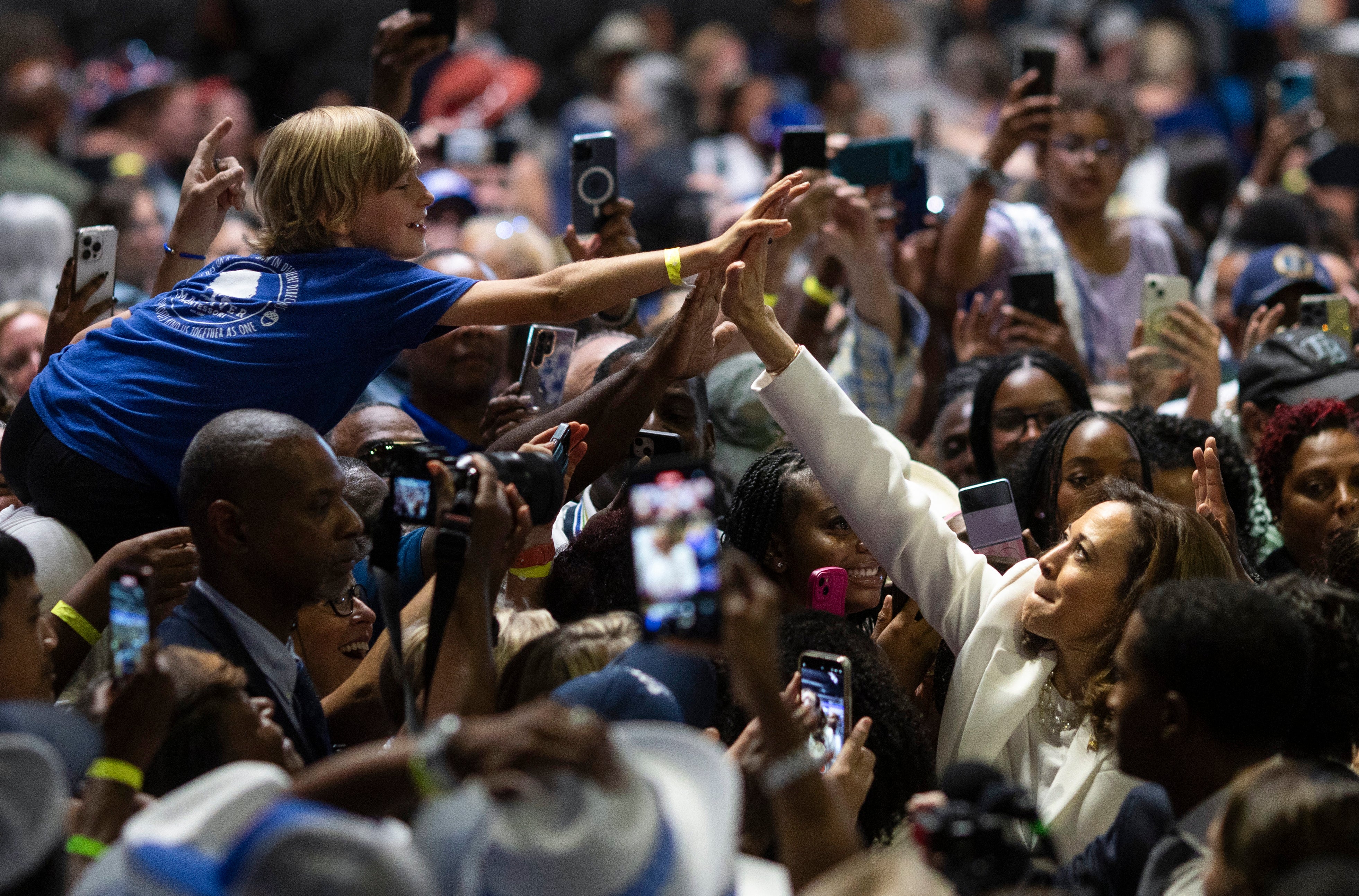 Kamala Harris high-fives a supporter at a rally in Savannah, Georgia on Thursday