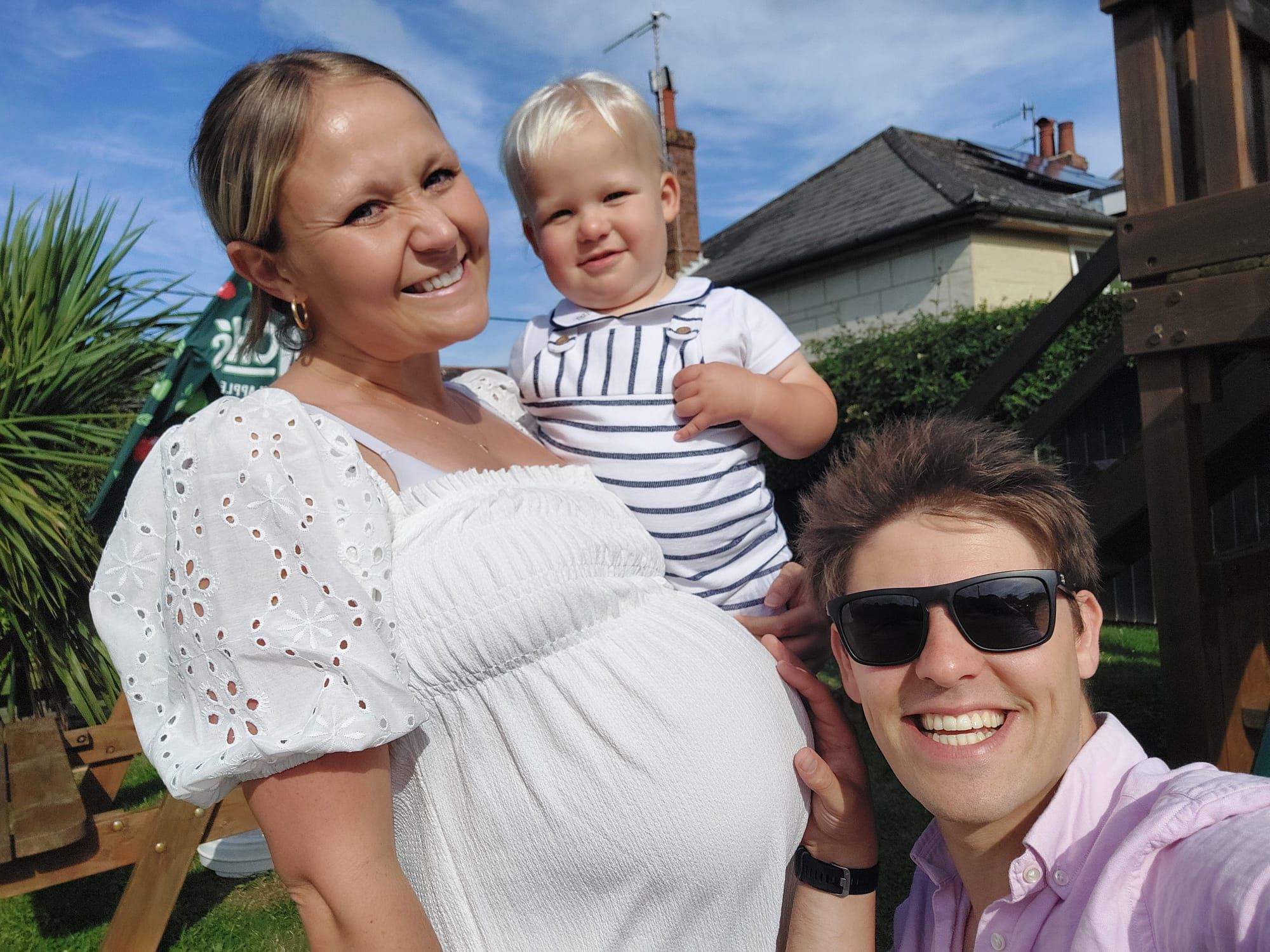 Rhiannon Woods with her husband Matt and son John – the couple are already preparing to register their unborn child to nursery due to the shortage of spaces