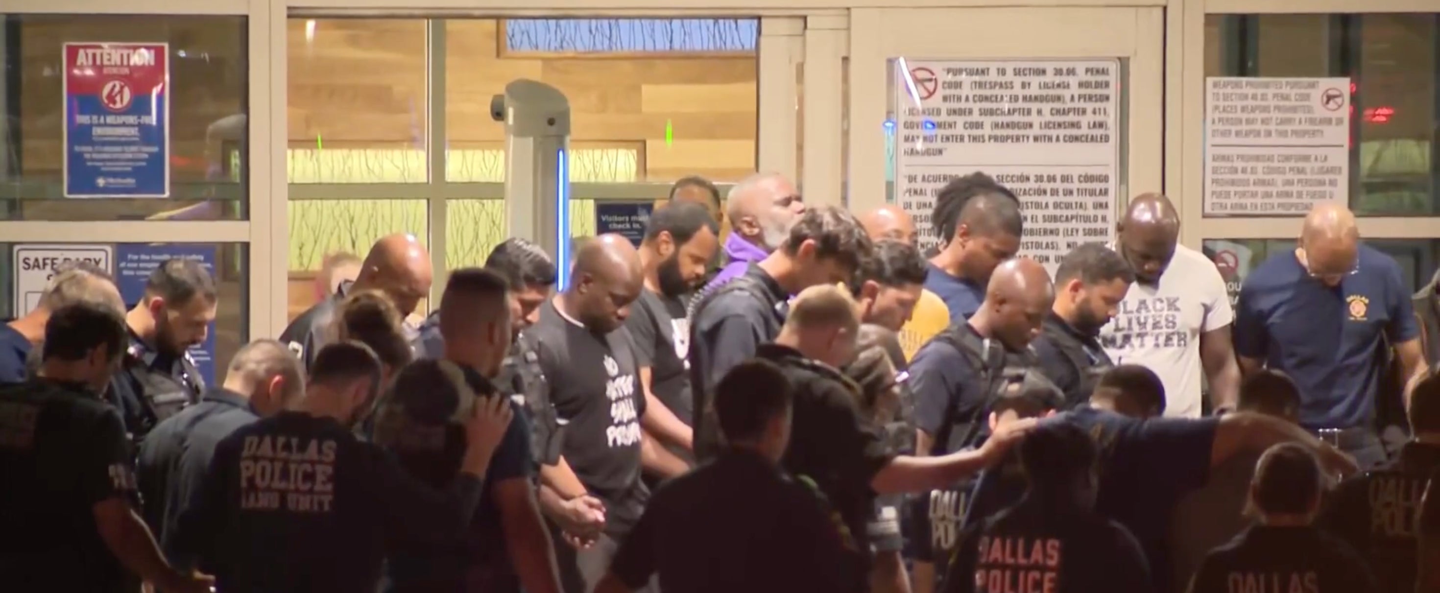 Police officers outside the hospital where their colleagues are being treated. Flags at all Dallas facilities will be flown at half-staff out of respect for the officer who died after being shot on Thursday