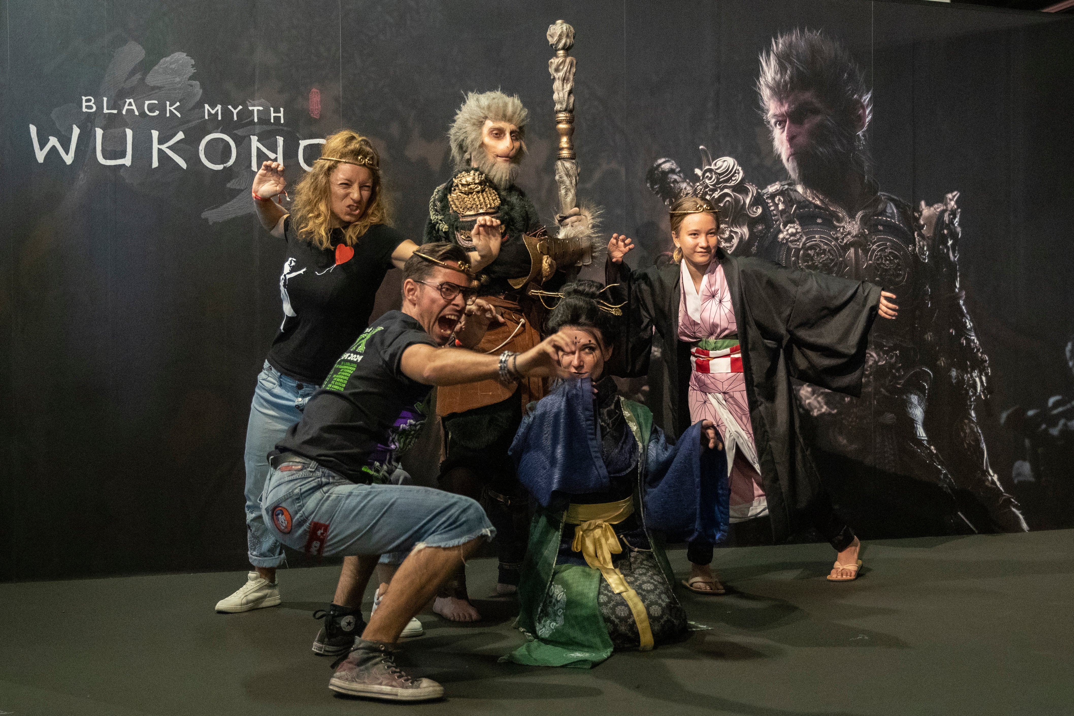 People take photos in front of a poster of ‘Black Myth: Wukong’ at the Game Science display during Gamescom 2024 in Cologne, Germany, on 22 August