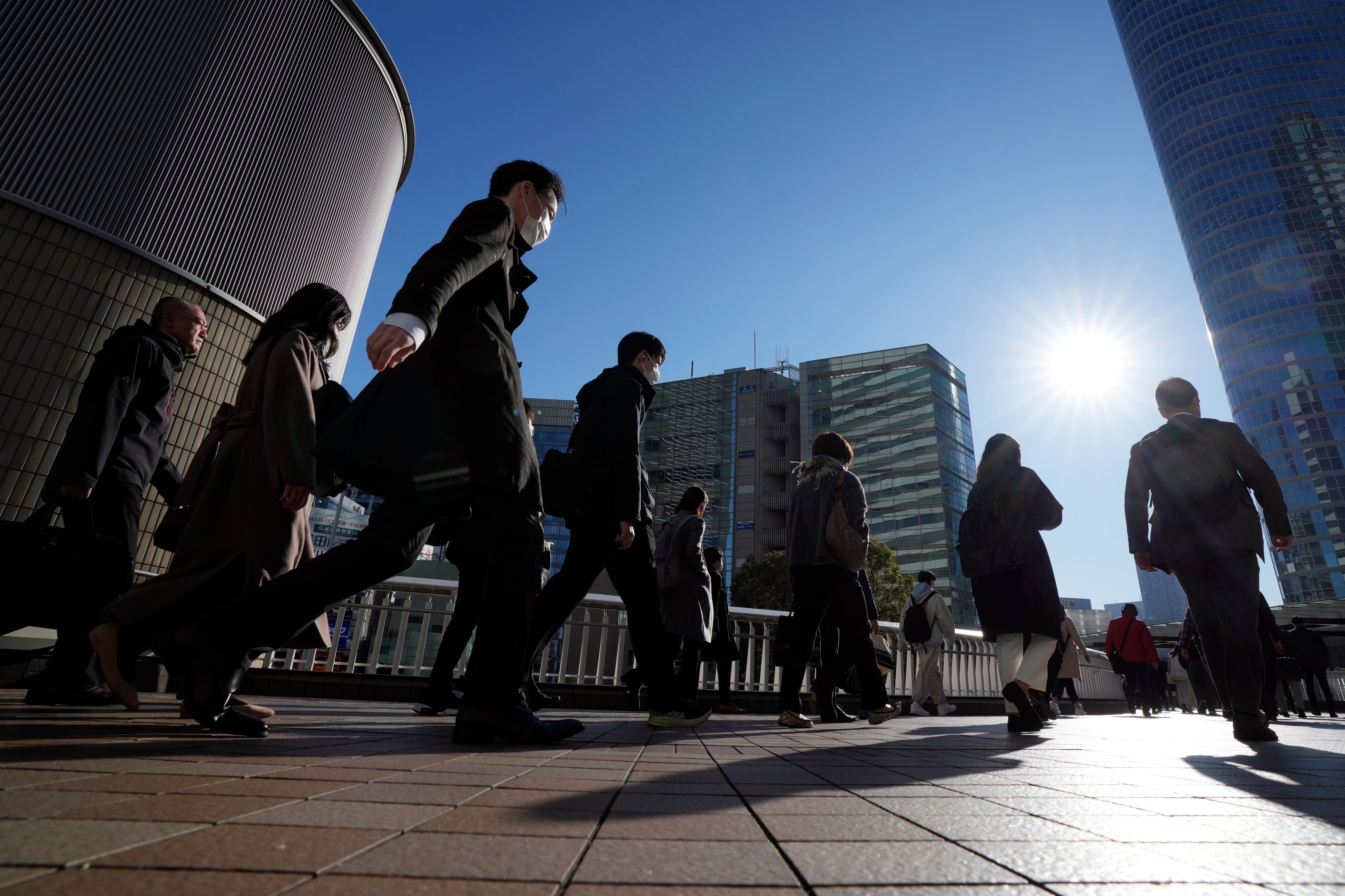 Commuters walk in a passageway during a rush hour at Shinagawa Station, Feb. 14, 2024, in Tokyo