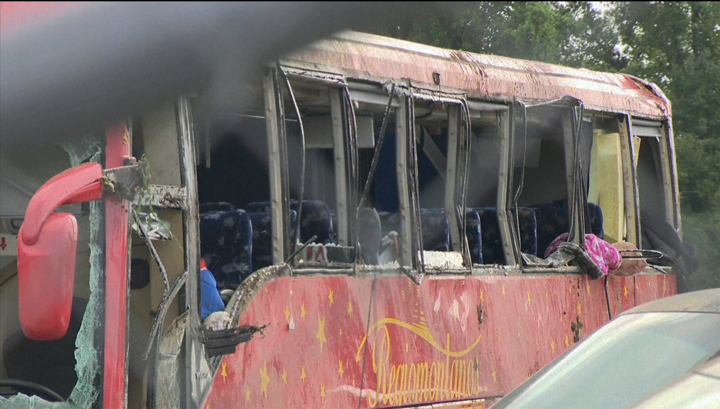 Damaged bus seen after several people were killed and dozens injured in crash