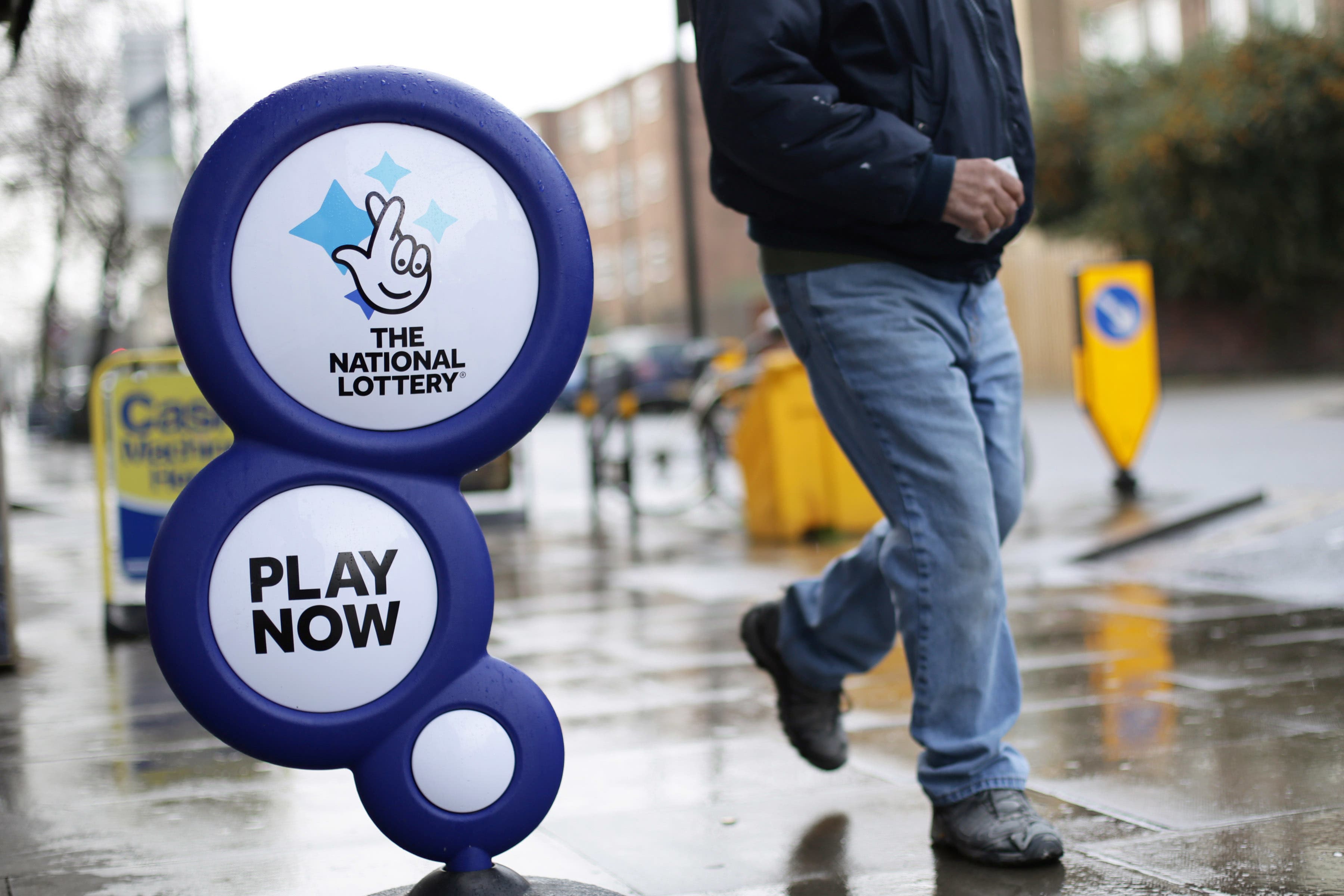 A National Lottery sign outside a newsagent in north London (Yui Mok/PA)