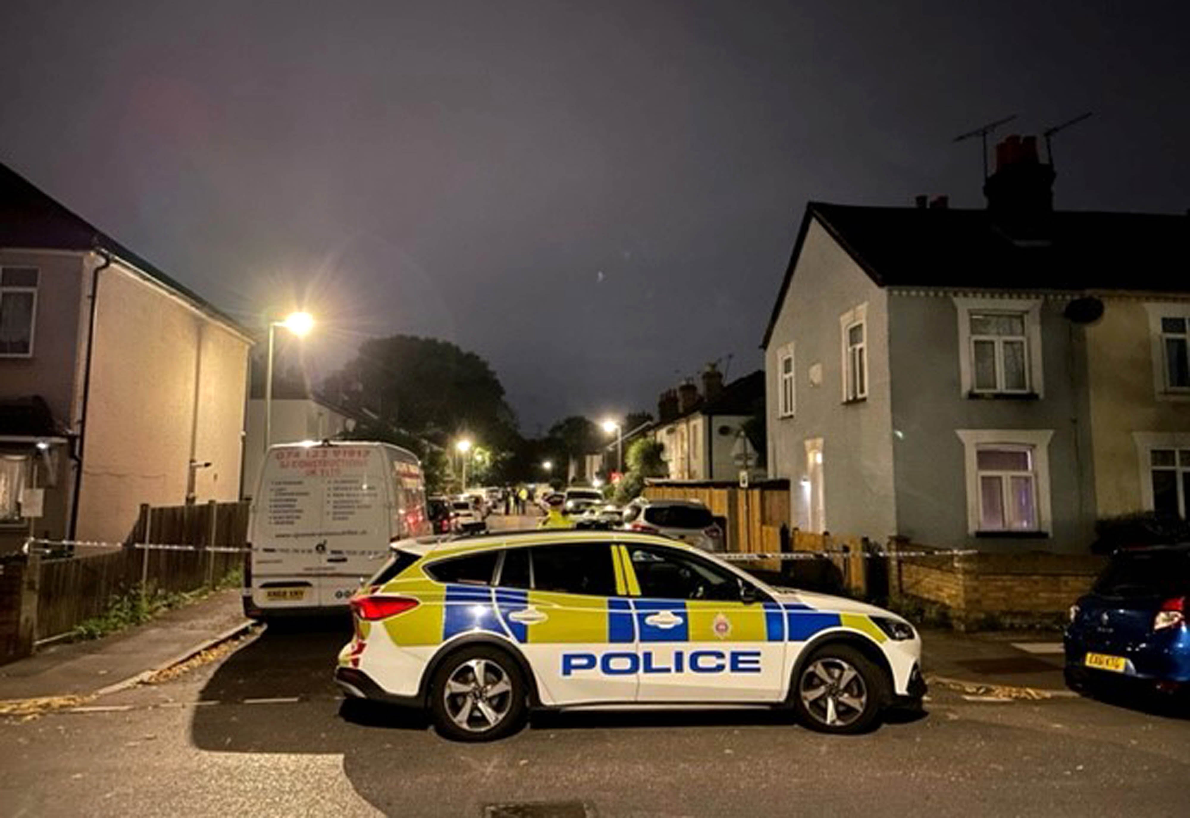 Police in Bremer Road, Staines-Upon-Thames near a property where three children and a man were found dead.