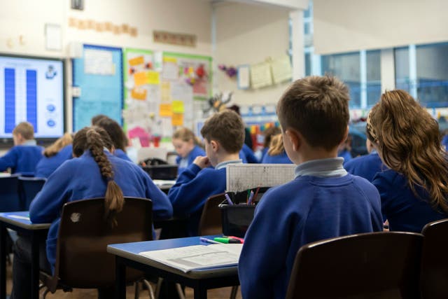 <p>School children during a Year 5 class (Danny Lawson/PA)</p>