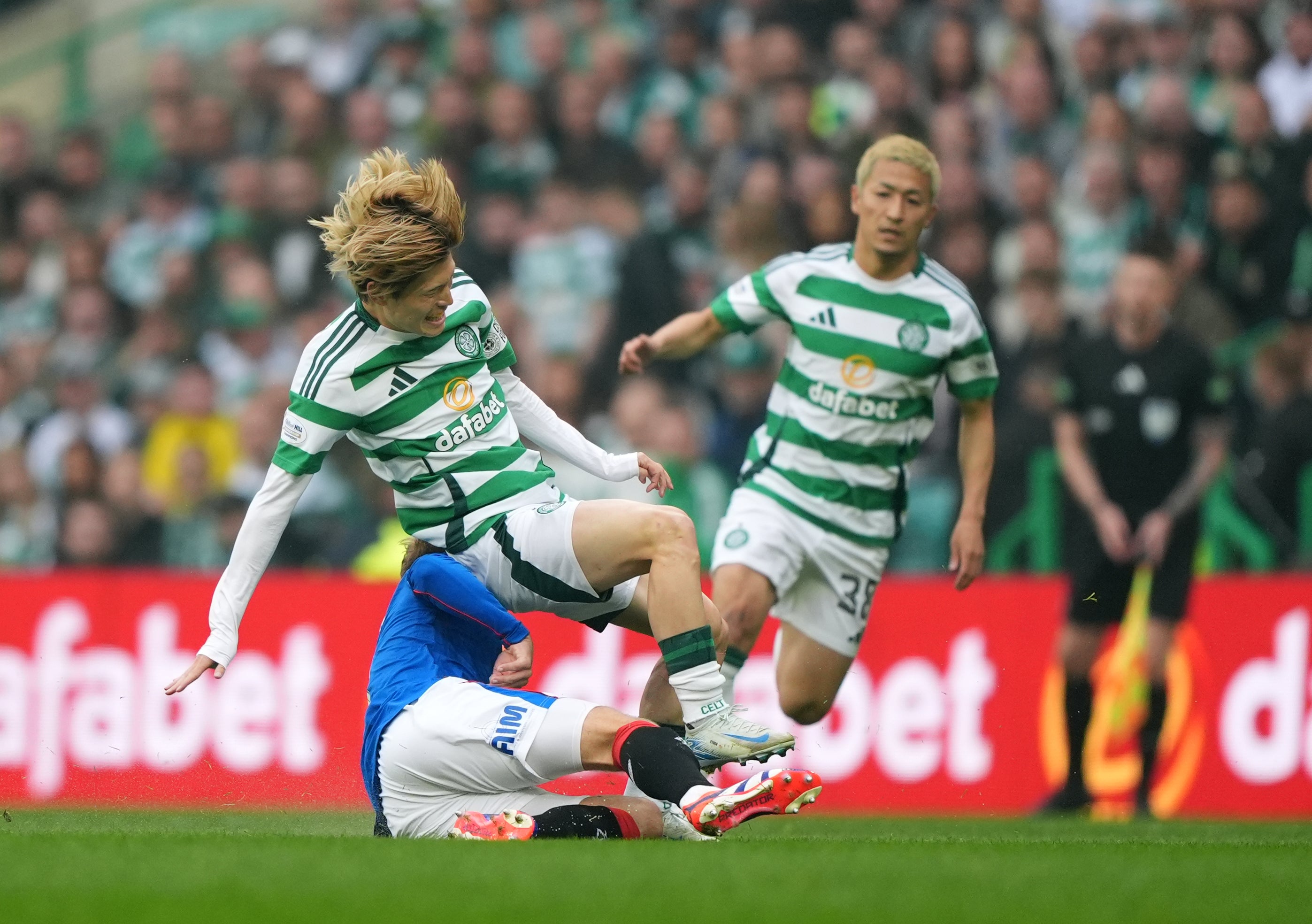 Rangers’ Connor Barron (left) and Celtic’s Kyogo Furuhashi battle for the ball