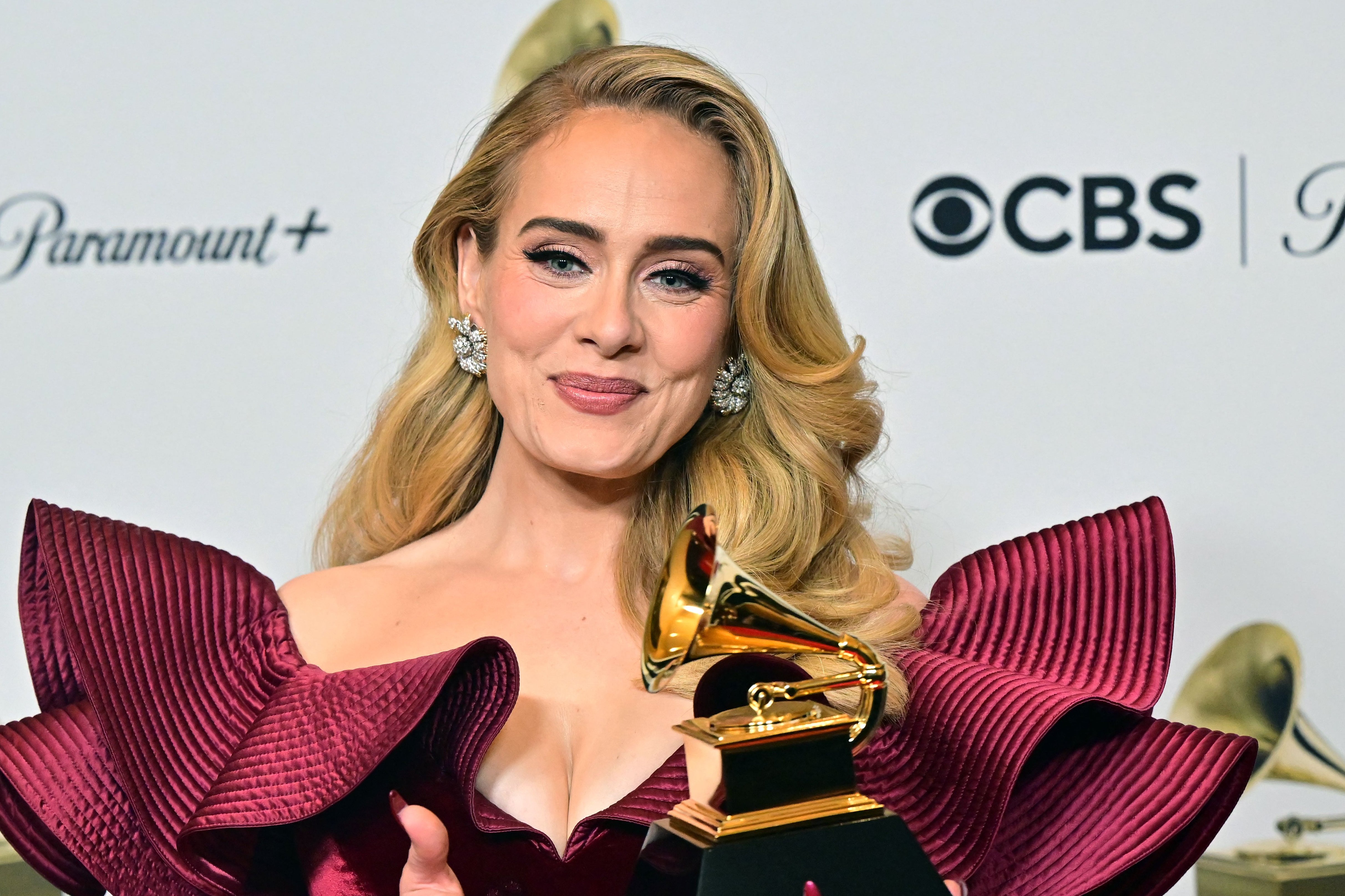 Adele poses with her Grammy for Best Pop Solo Performance for "Easy on Me" in February 2023