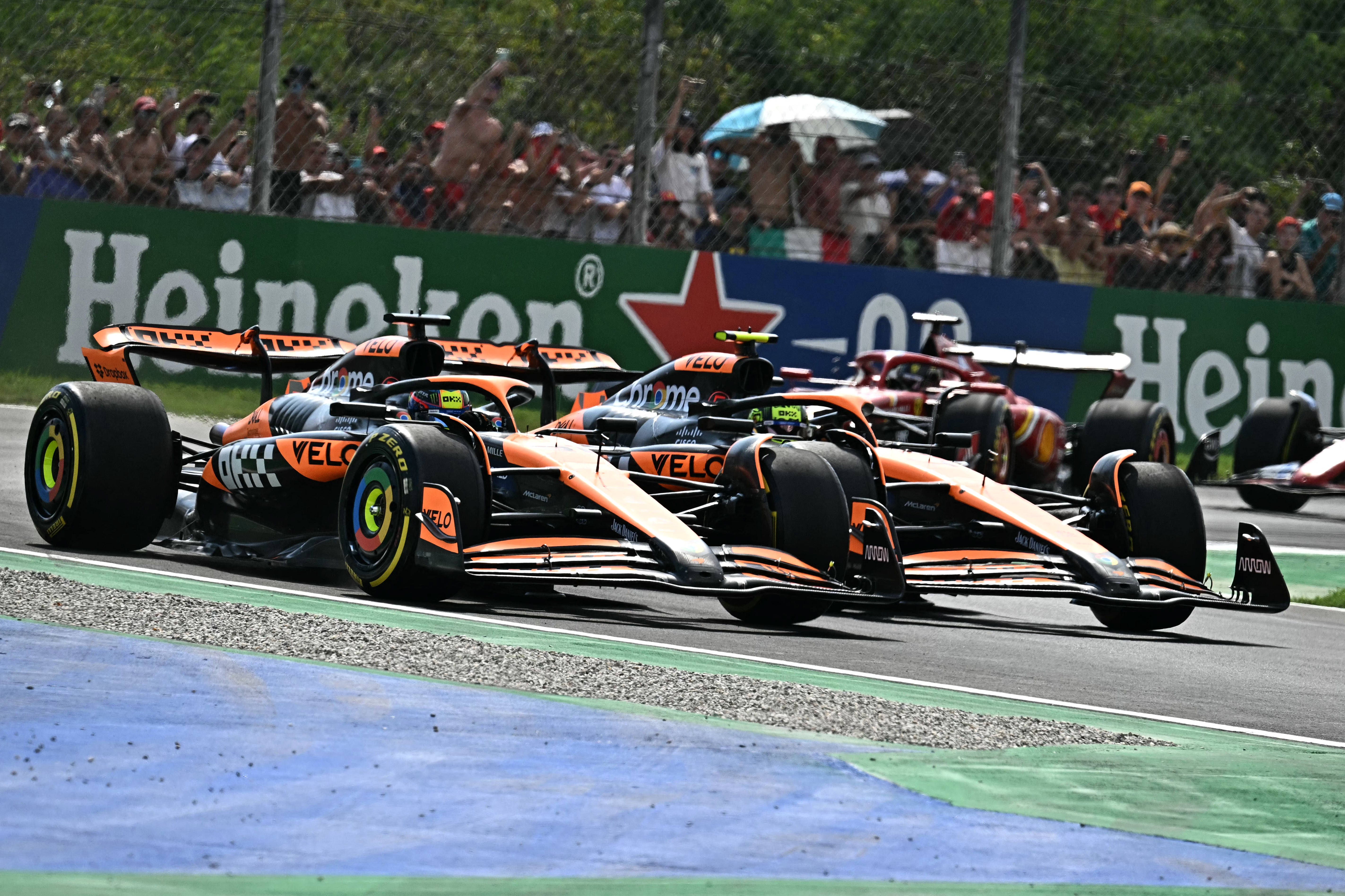 McLaren’s Oscar Piastri overtakes teammate Lando Norris on lap one at Monza