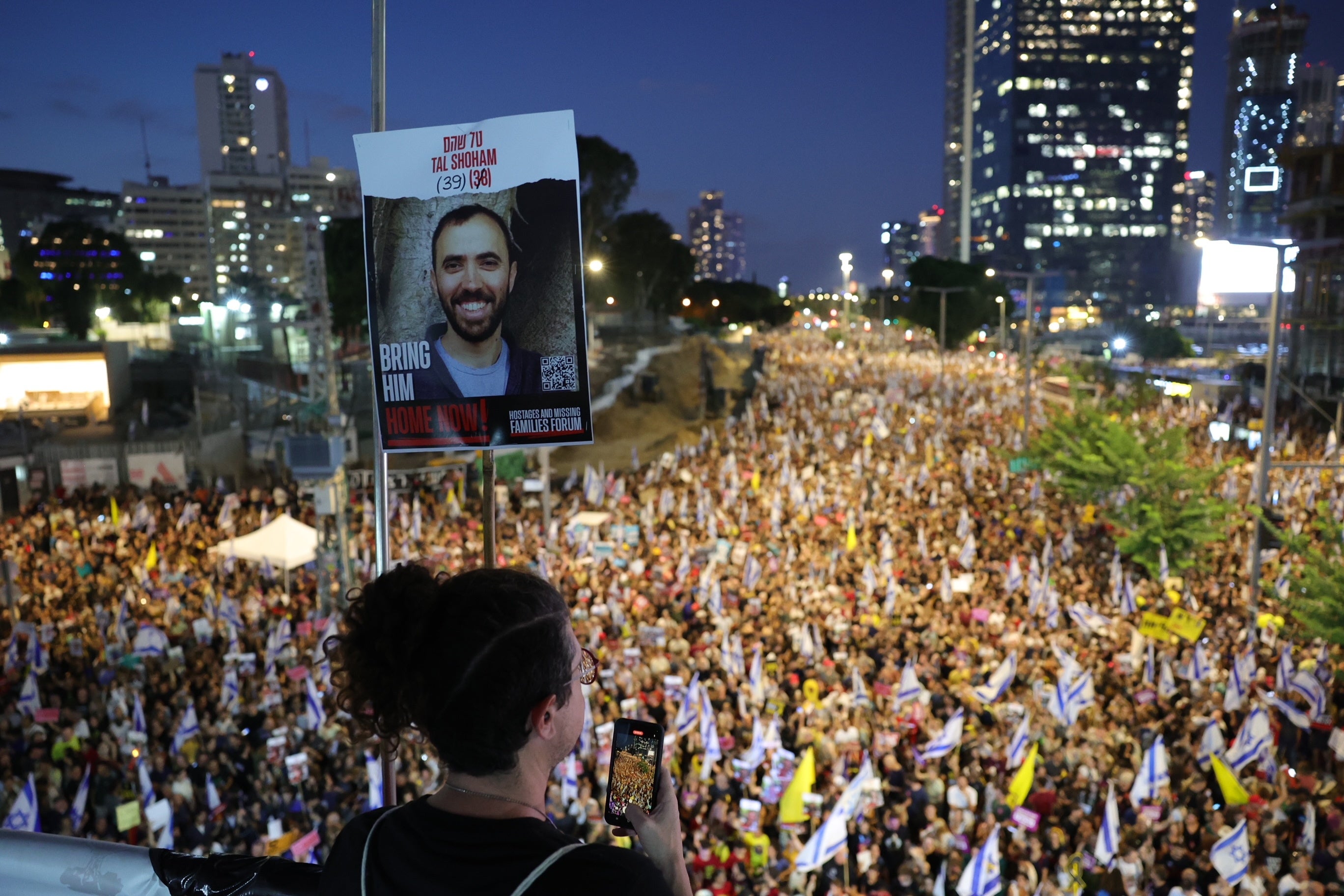 Thousands of demonstrators supporting the families of Israeli hostages held by Hamas in Gaza take part in a protest rally outside the Kyria military headquarters in Tel Aviv