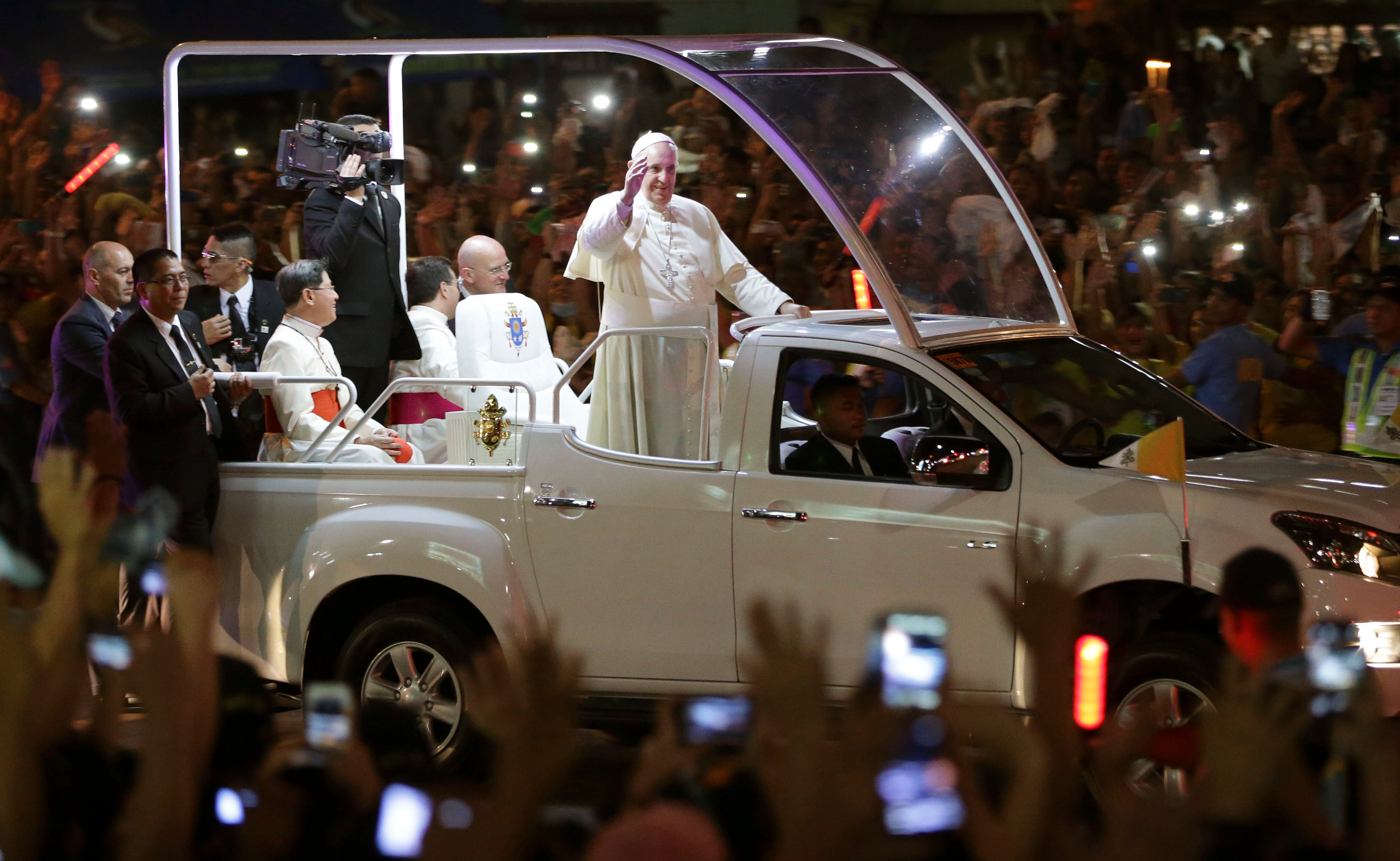 Pope Francis waves to Filipinos upon his arrival in Manila, Philippines, Thursday, Jan. 15, 2015