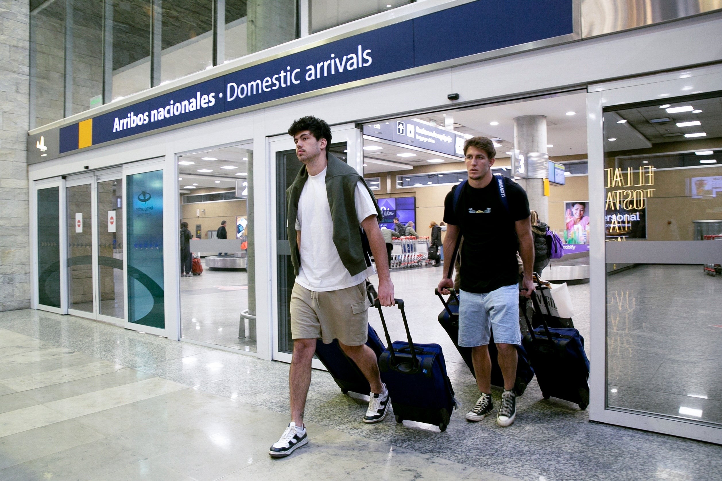 French rugby players Oscar Jegou, right, and Hugo Auradou arrive from Mendoza at the airport in Buenos Aires