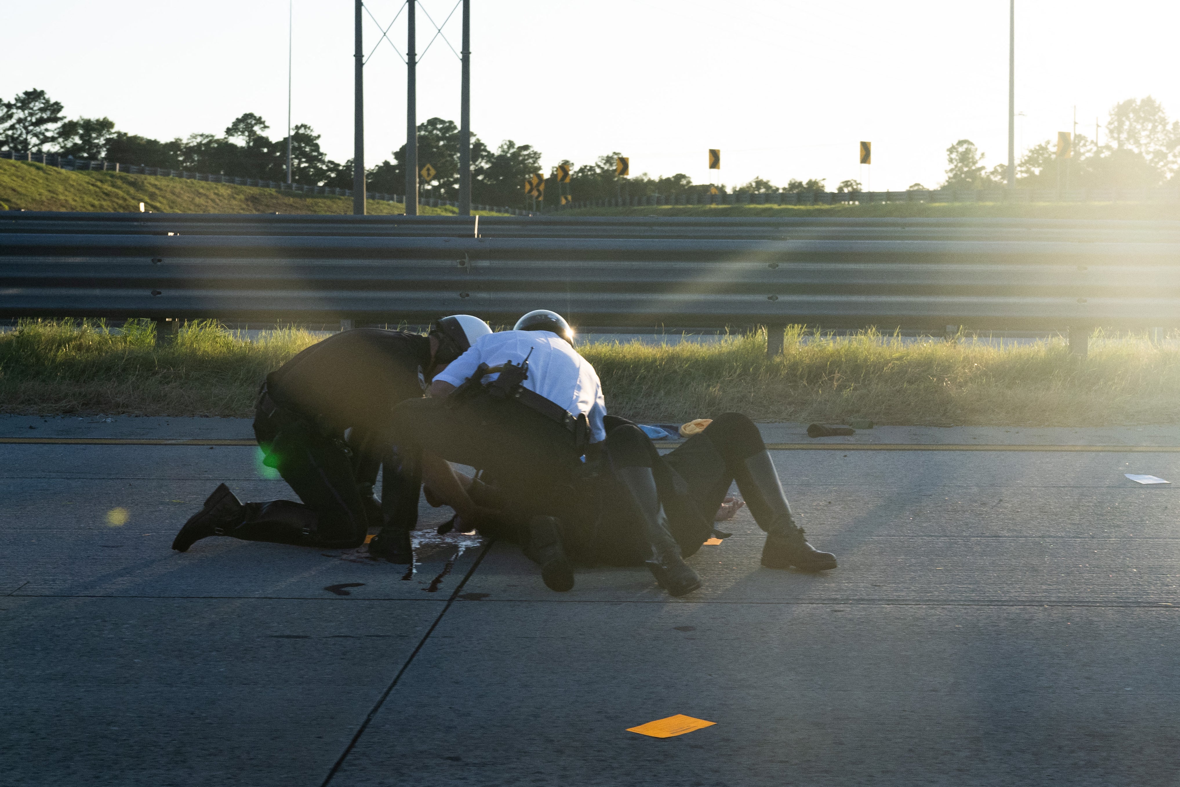 Police attend to Savannah, Georgia police officer David Bates, who crashed as part of the Harris-Walz motorcade on August 28