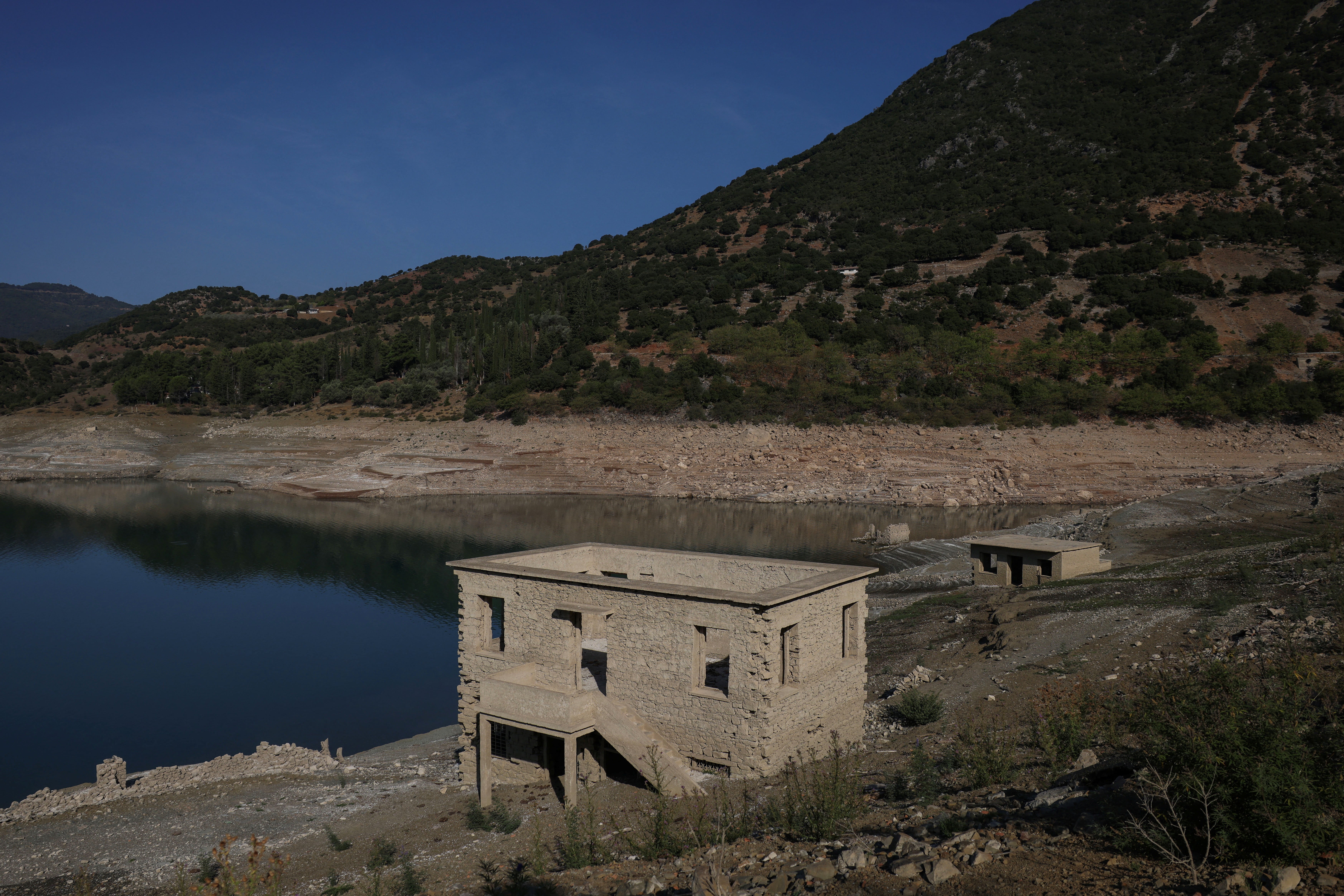 The reappearing remains of buildings of the village of Kallio, which was intentionally flooded in 1980 to create a reservoir that would help meet the water needs of Greek capital Athens