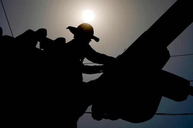 <h4>A linesman works on power lines under the Phoenix sun this  July. Arizona’s capital has seen 100 days of sweltering 100-degree temperatures since May 27, according to the National Weather Service. The last record, in 1993, was 76 days. The city is not expected to have relief any time soon, with another week of triple-digit temperatures forecast. </h4>