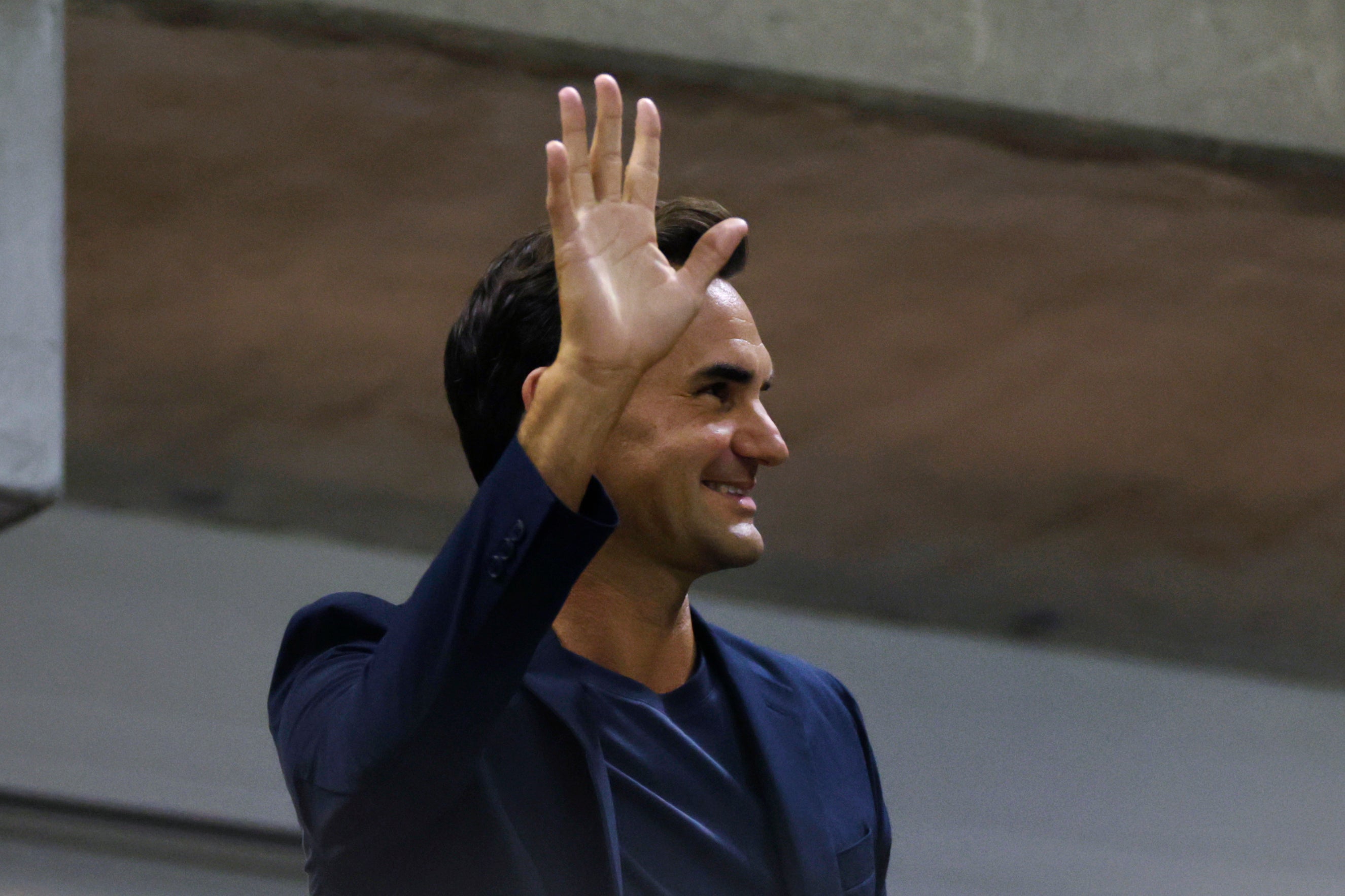 Tennis star Roger Federer waves to the crowd during the quarterfinal match between Aryna Sabalenka of Belarus and Zheng Qinwen of China at the U.S. Open, Tuesday, Sept. 3, 2024, in New York. (AP Photo/Adam Hunger)