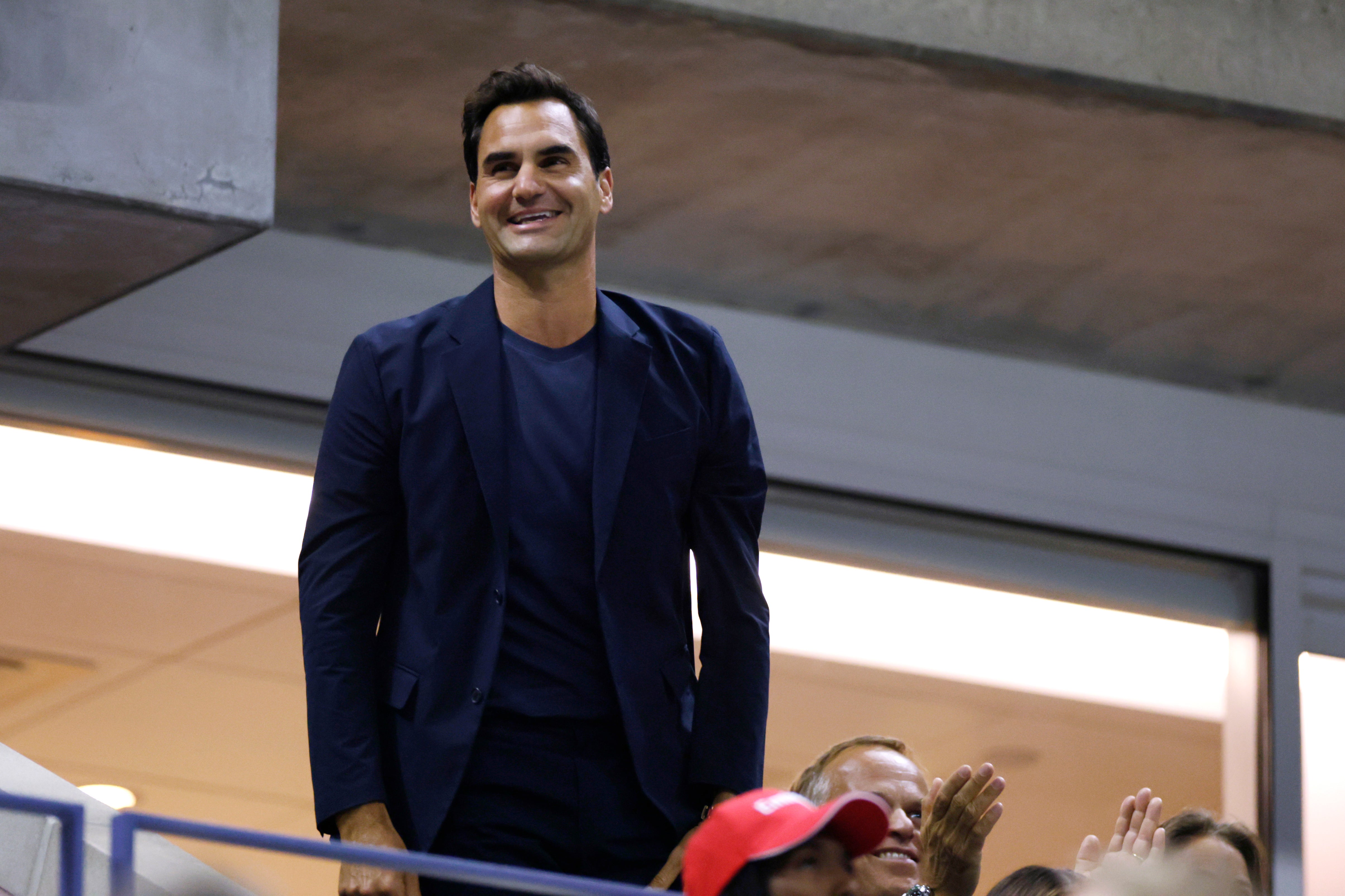 Tennis star Roger Federer greets the crowd during the quarterfinal match between Aryna Sabalenka of Belarus and Zheng Qinwen of China at the U.S. Open, Tuesday, Sept. 3, 2024, in New York. (AP Photo/Adam Hunger)