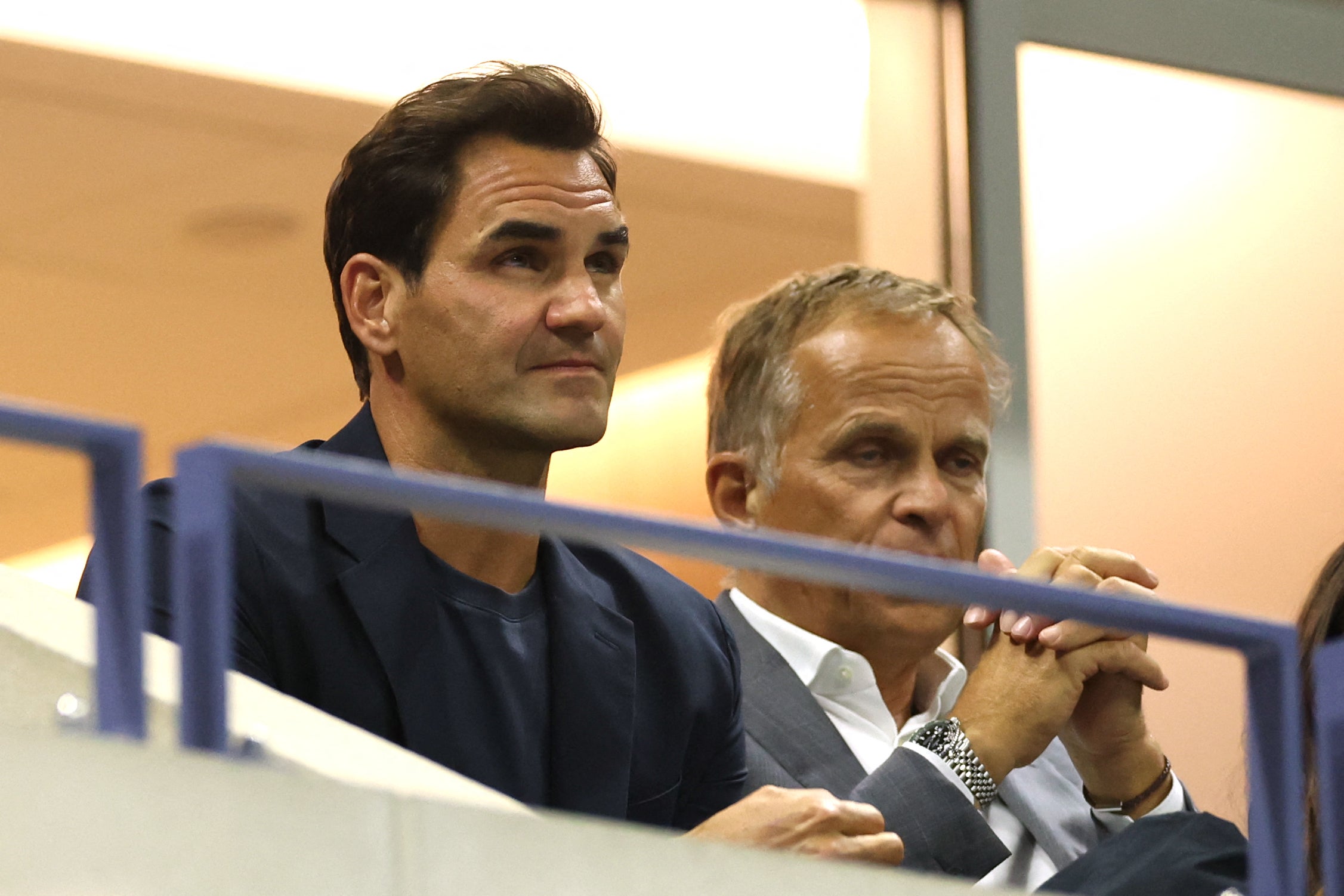 Former Swiss professional tennis player Roger Federer (left) attends the women's singles quarterfinal match between Belarus' Aryna Sabalenka and China's Zheng Qinwen on day nine of the US Open tennis tournament at the USTA Billie Jean King National Tennis Center in New York City on September 3, 2024. (Photo by CHARLY TRIBALLEAU / AFP) (Photo by CHARLY TRIBALLEAU/AFP via Getty Images)