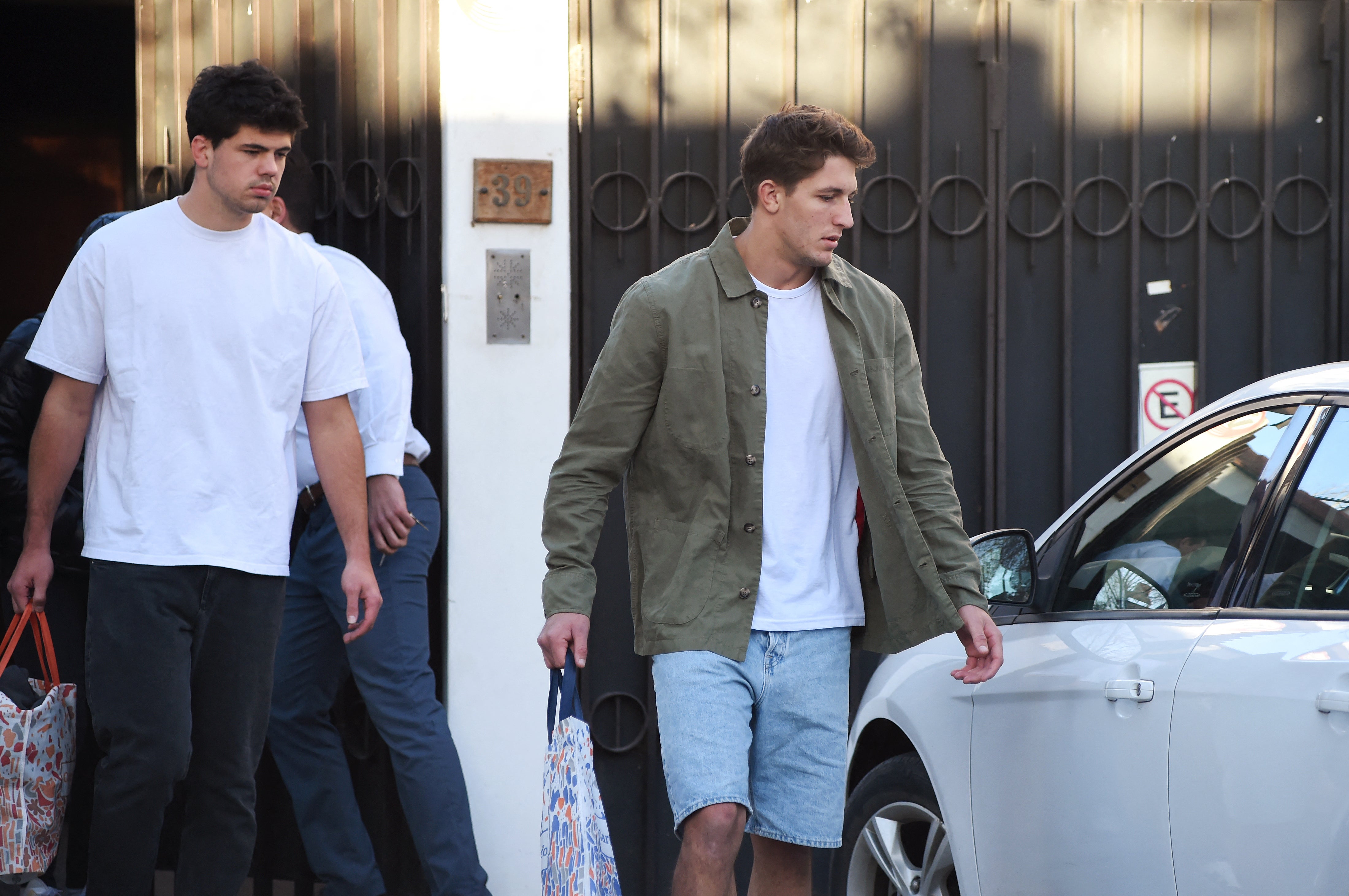 French rugby players Hugo Auradou (L) and Oscar Jegou leave the house in which they served house arrest in Mendoza