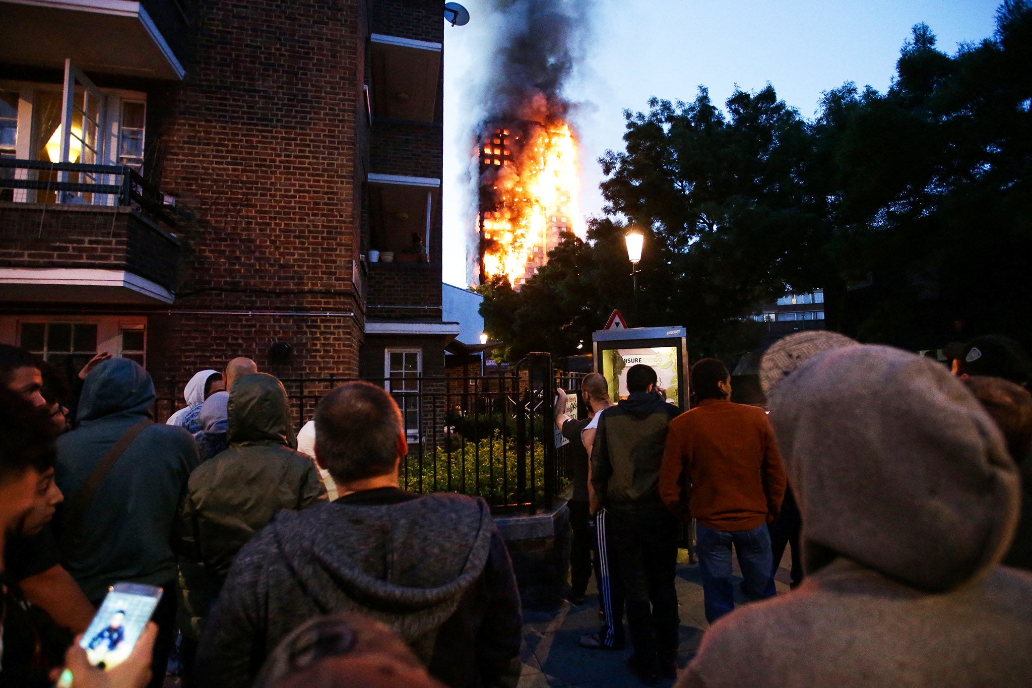 Local residents watch as Grenfell Tower is engulfed by fire