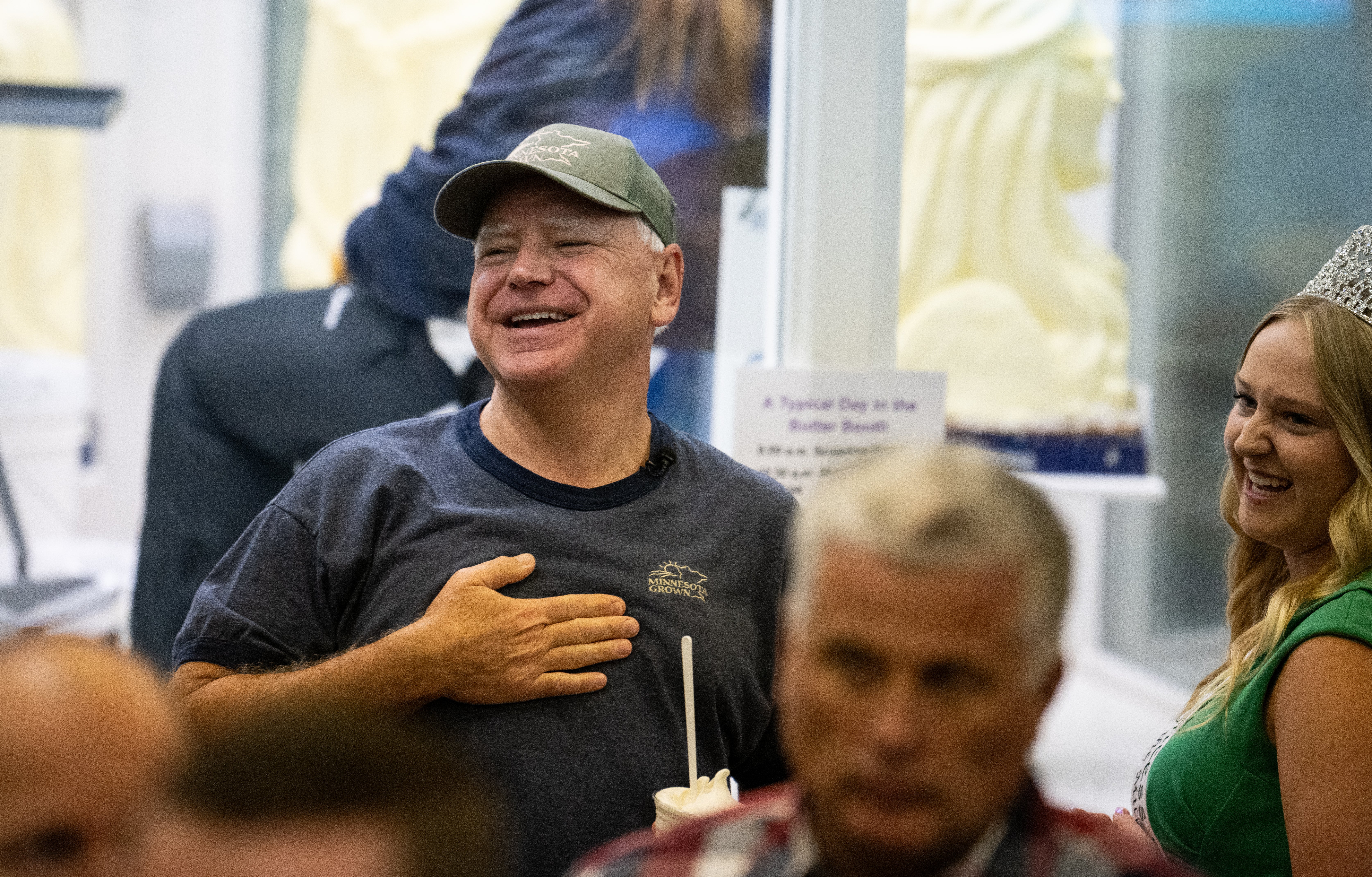 Democratic vice presidential nominee Minnesota Gov. Tim Walz speaks with Rachel Visser, the 71st Princess Kay of the Milky Way, as they look at the butter sculptures in the Dairy Barn in the Minnesota State Fair on September 1.