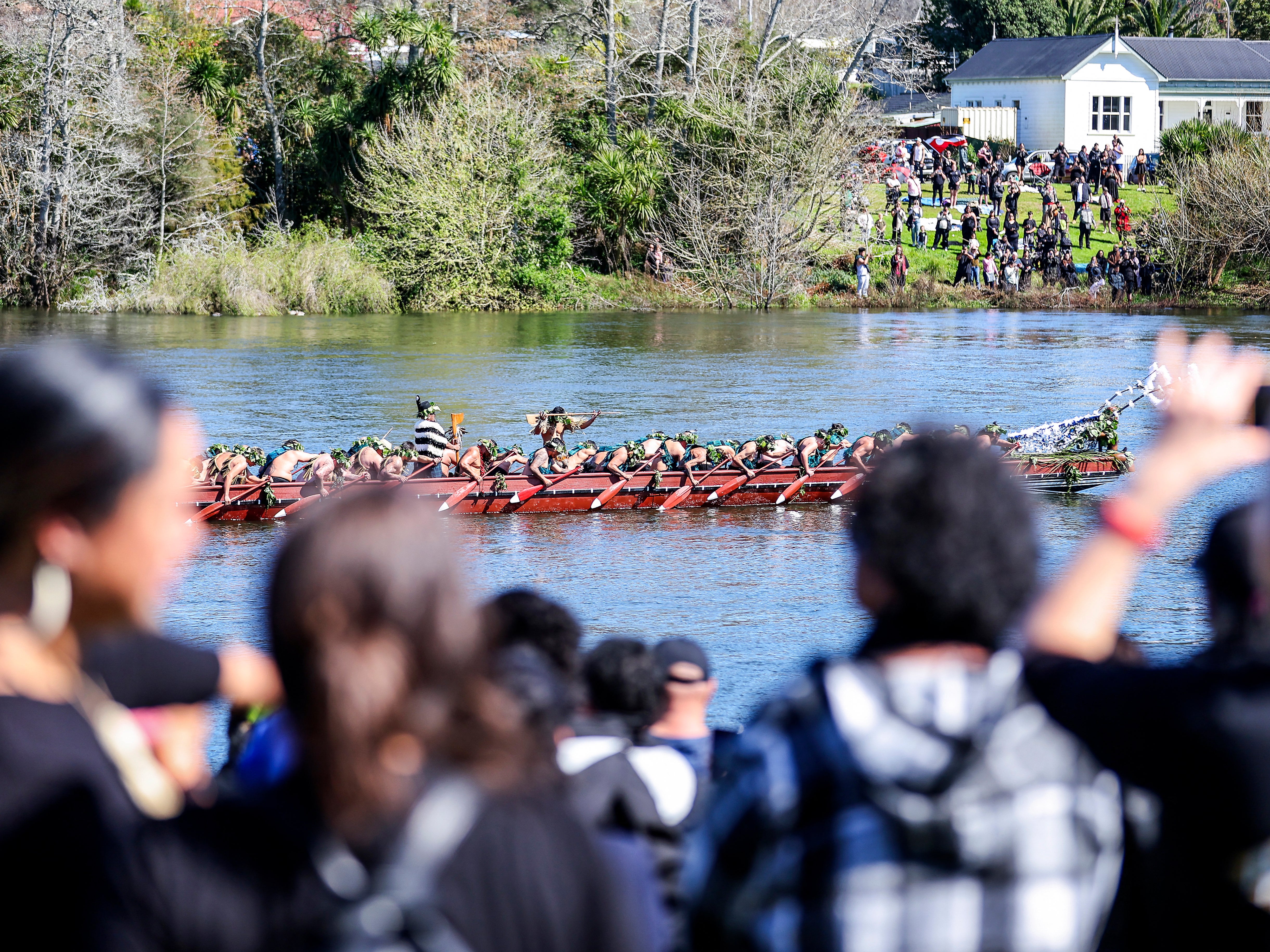 Maori warriors paddle waka canoes down towards Taupiri Maunga during the funeral ceremony of King Tuheitia Pootatau Te Wherowhero VII in Ngaruawahia on 5 September 2024.