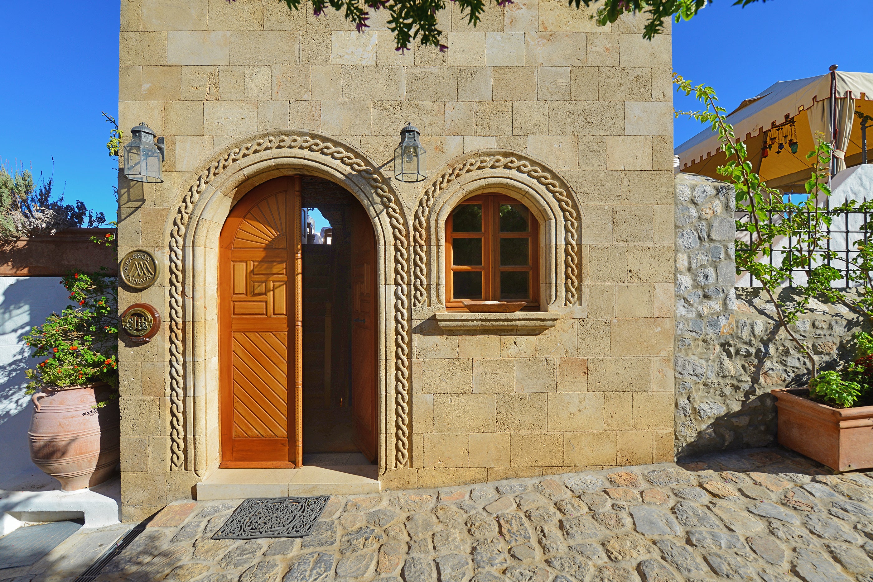 Melenos sits of the quiet side of medieval Lindos