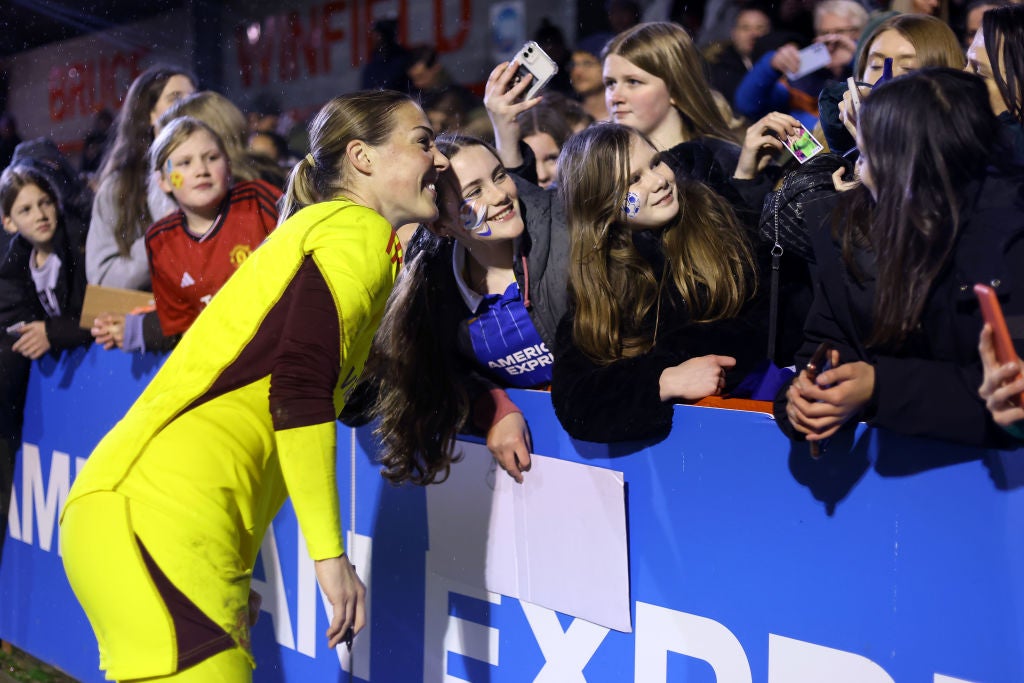 Mary Earps, who has since joined PSG, stops for a photo with a Manchester United fan